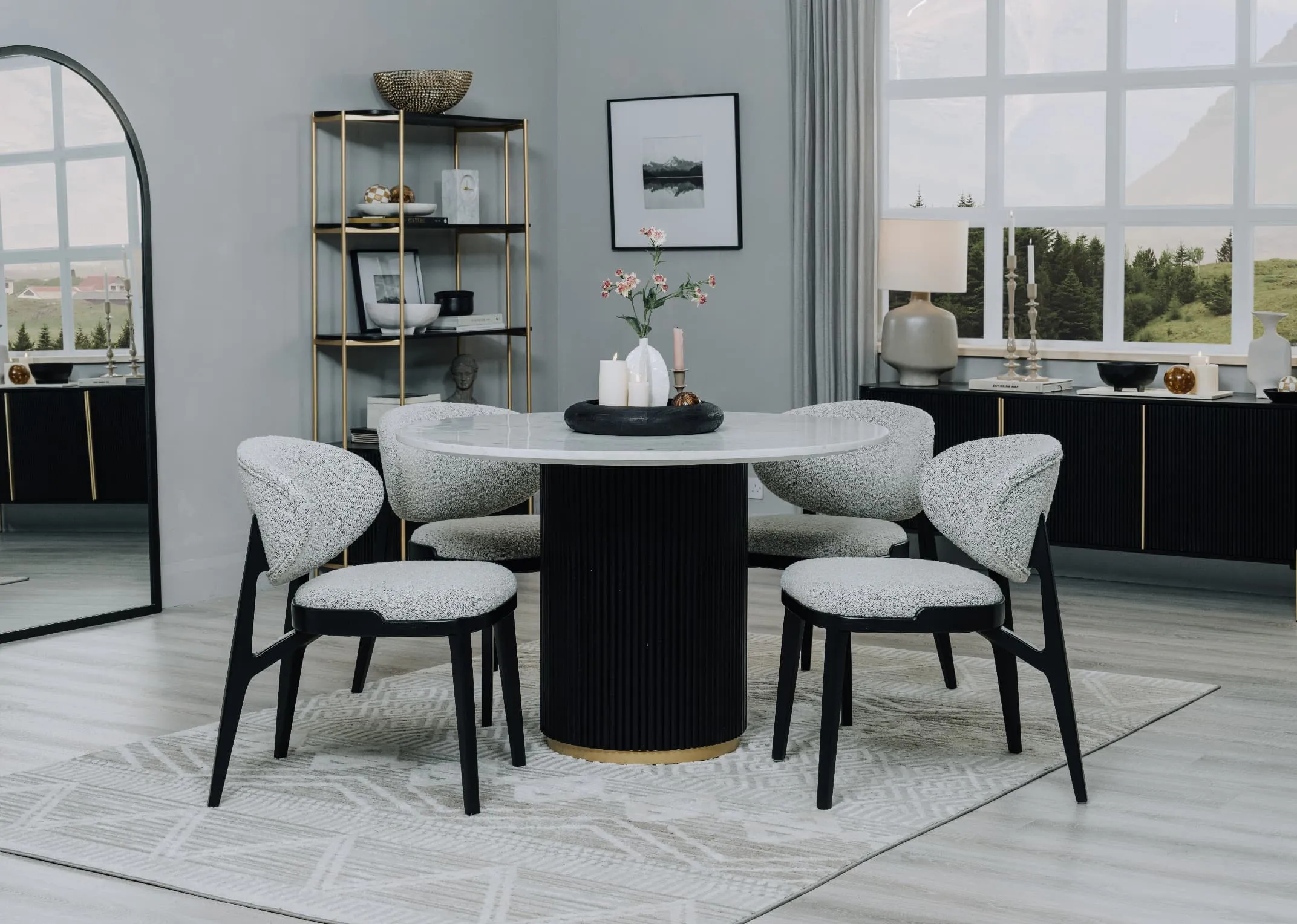 A lifestyle image of the Rego round dining table with Joey dining chairs and Chrisley mirror.