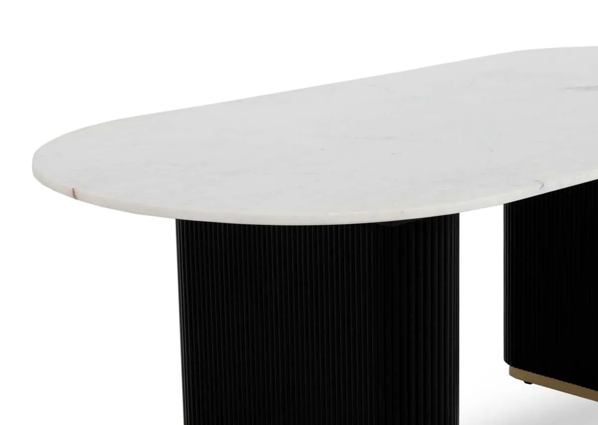 An oval white marble dining table top with black mango wide legs from EZ Livings Rego range. Closeup of marble finish.