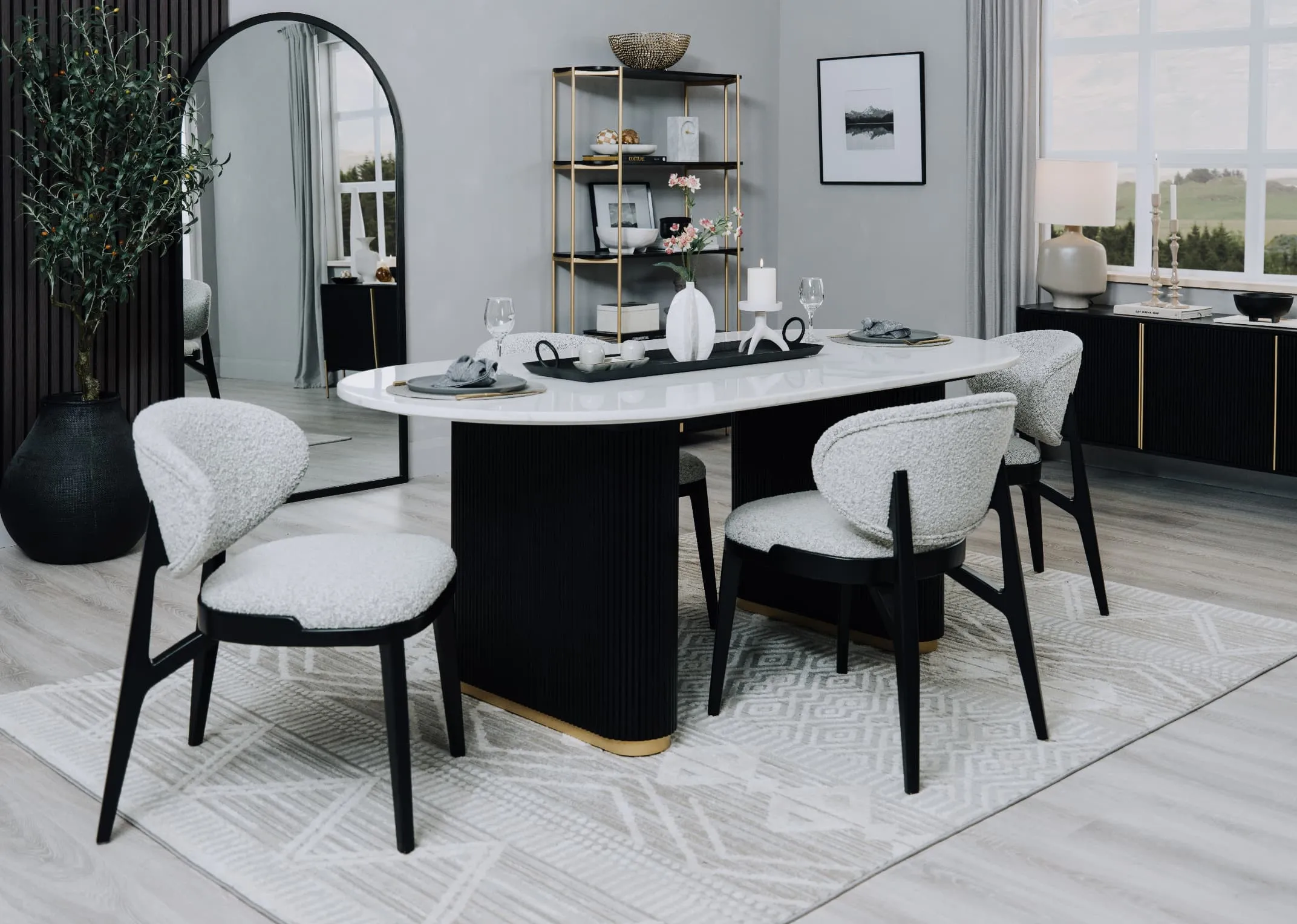 A lifestyle image of the Rego oval dining table with Joey dining chairs and Rego bookcase.