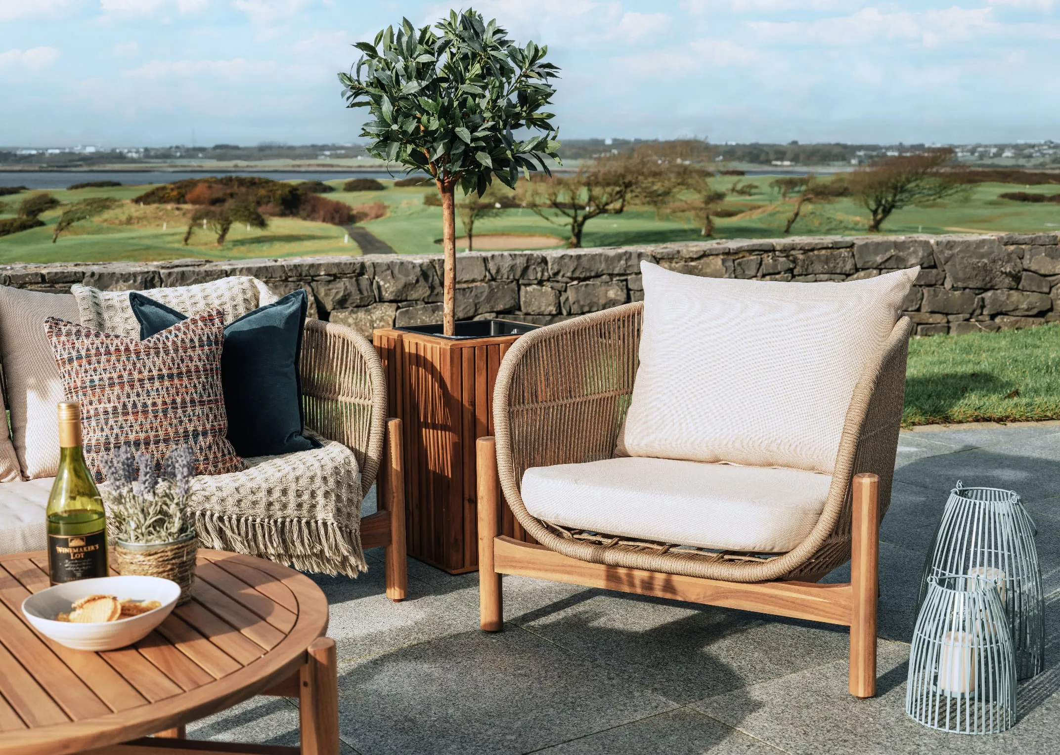 A lifestyle image of the La Palma Garden set with closeup on armchair and river lanterns