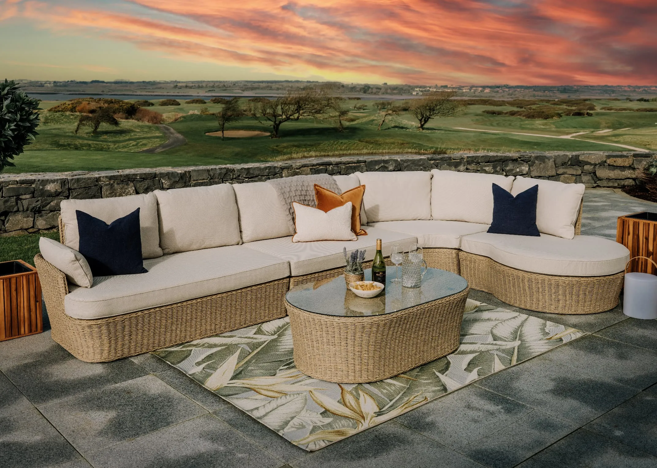 A white corner sofa with wicker base from EZ Livings Saint Tropez range. Angled view of wicker base and white polypropelene fabric.