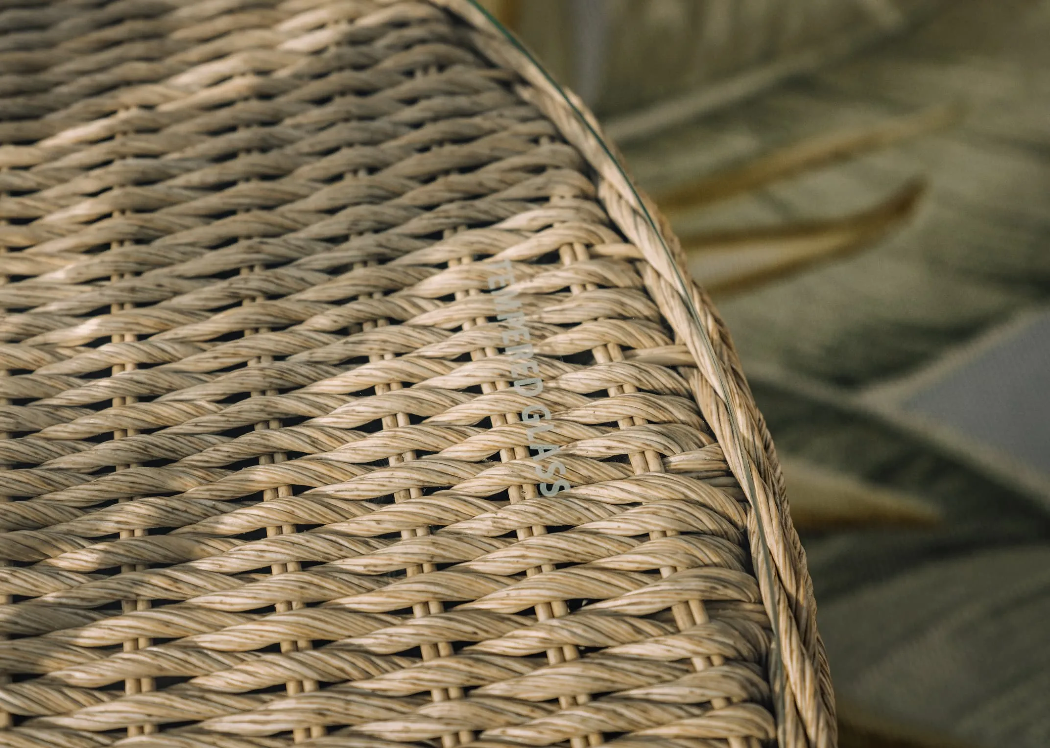 A white corner sofa with wicker base from EZ Livings Saint Tropez range. Closeup of 2 seater