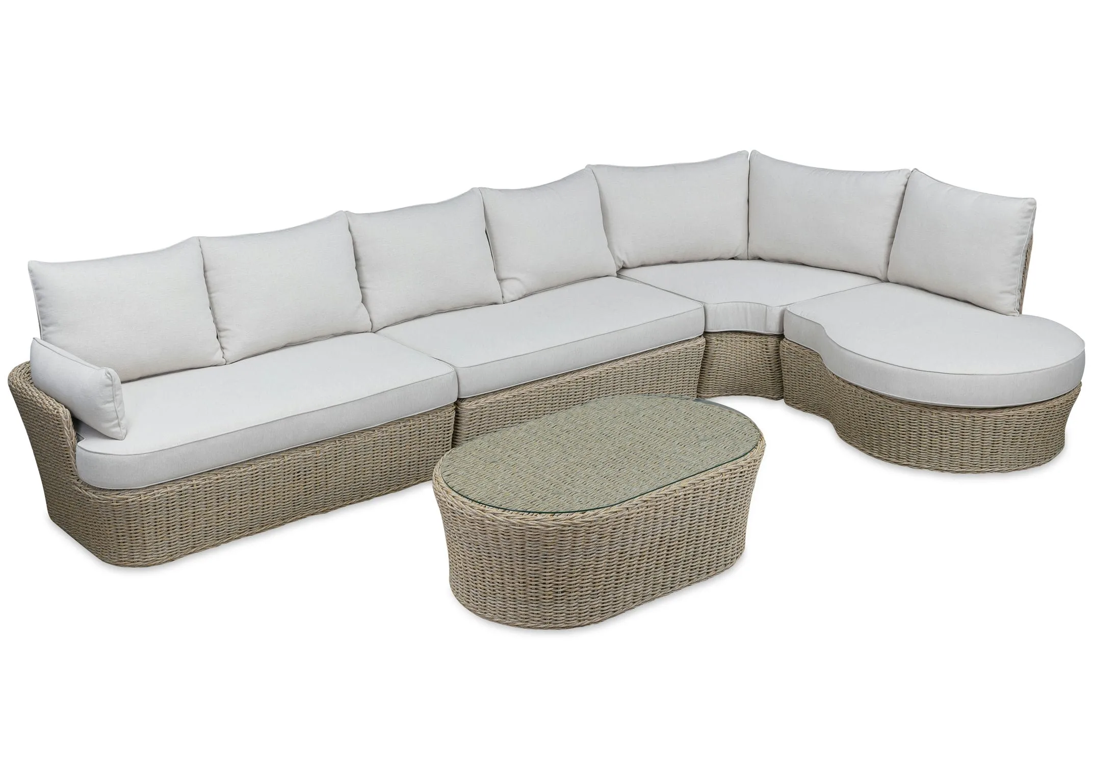 A white corner sofa with wicker base from EZ Livings Saint Tropez range. Angled view of oval coffee table.