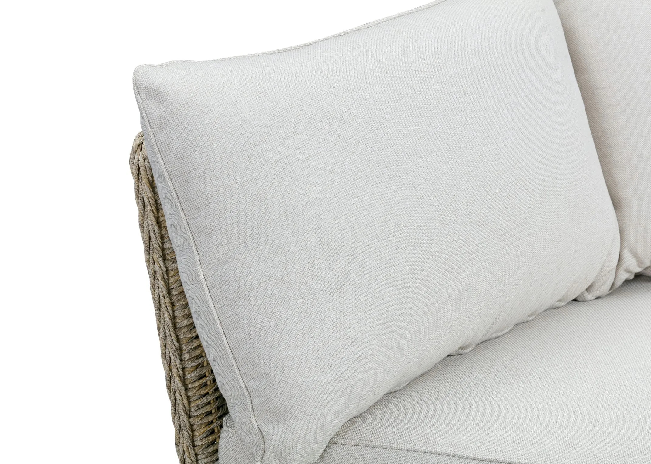 A white corner sofa with wicker base from EZ Livings Saint Tropez range. Closeup of off white fabric