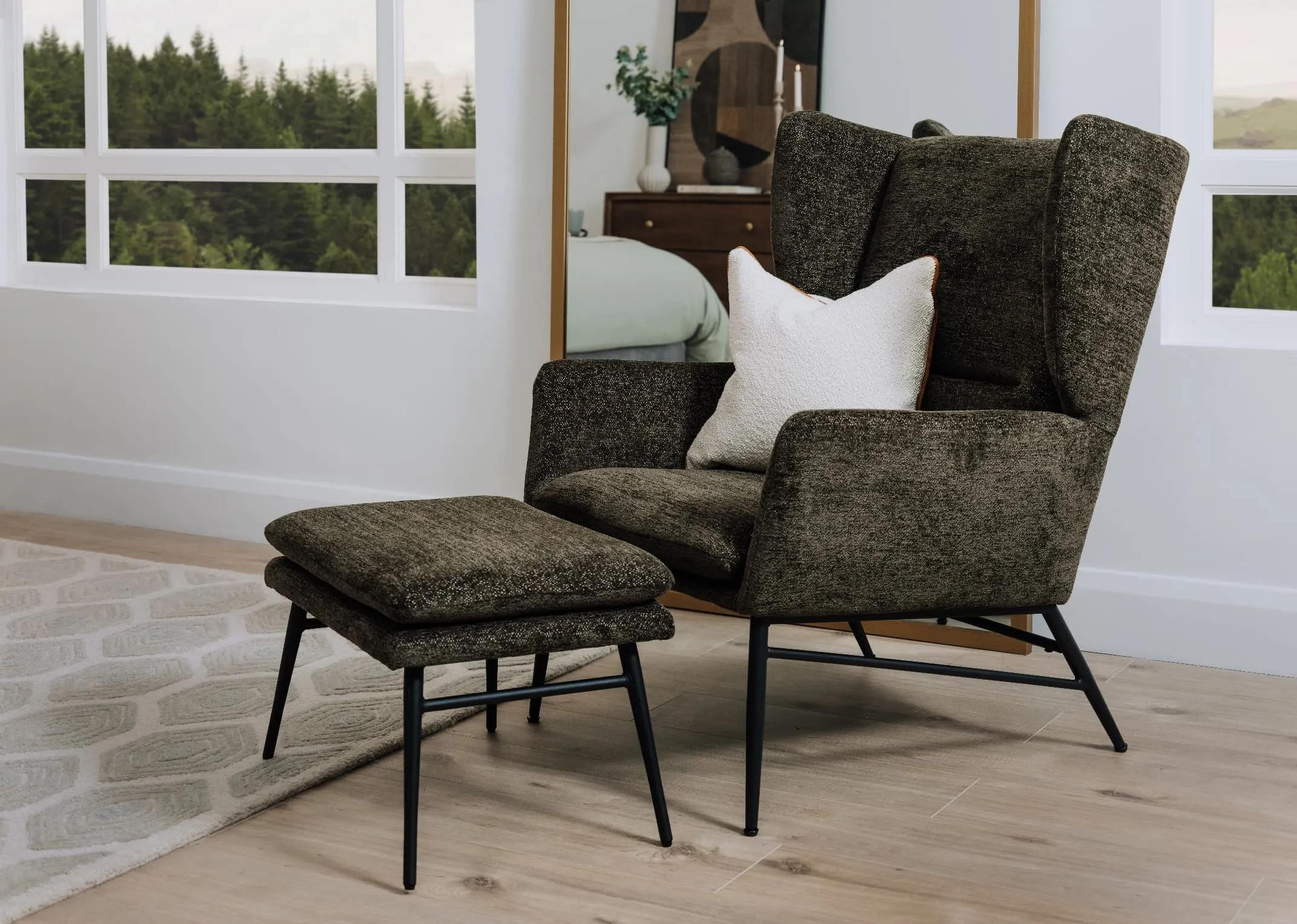 A lifetsyle image of the Boston green chair and matching footstool