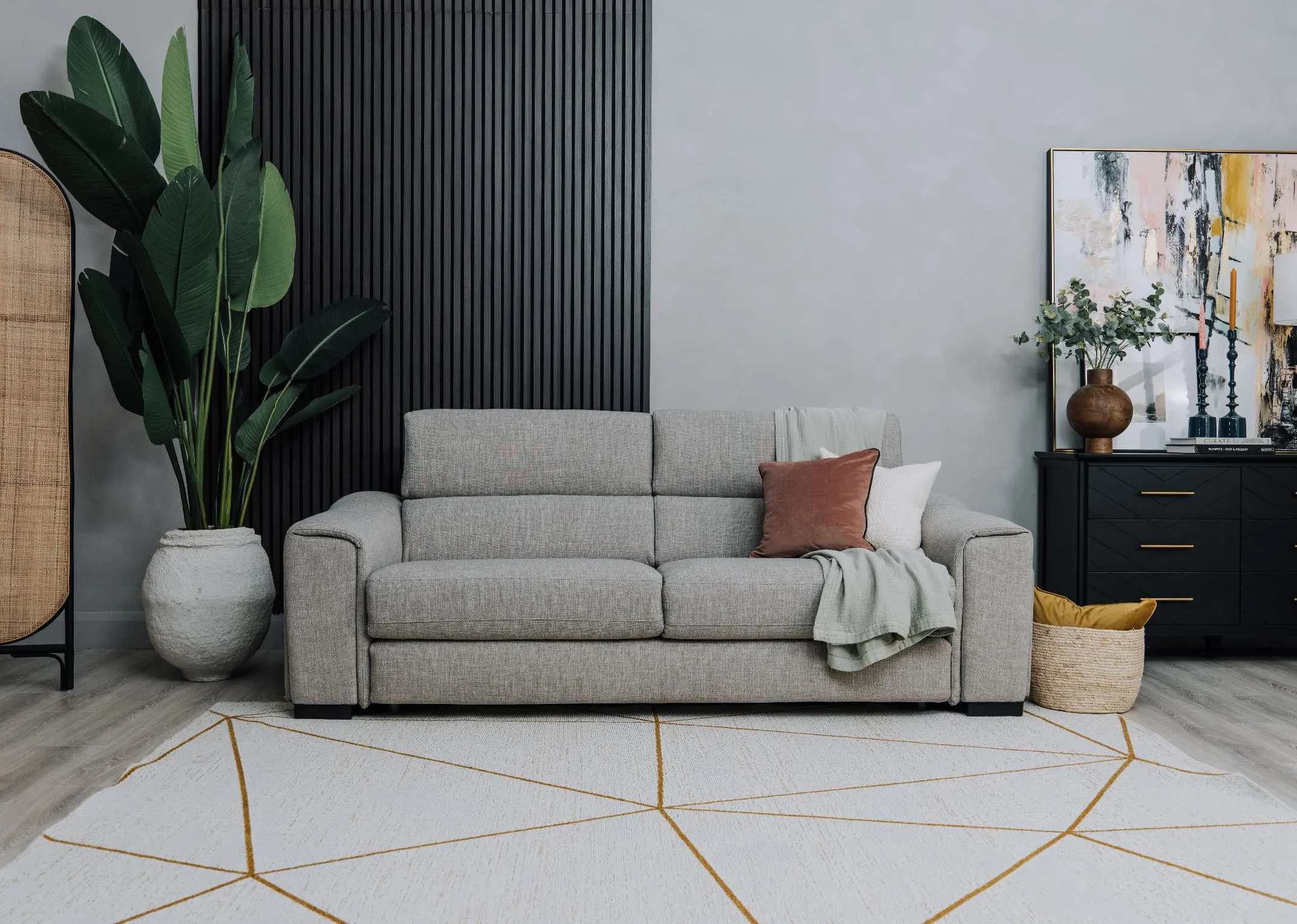 A lifestyle image of the Charvi rug with the Murano sofabed and Chevron chest.
