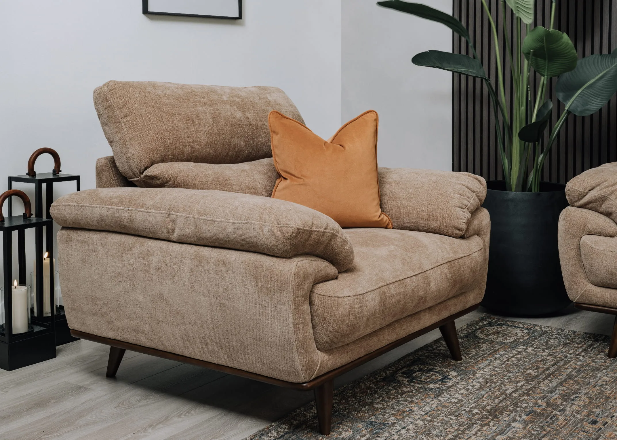 A lifetsyle image of the Pippa Armchair with gold velvet cushion and Maxima rug.