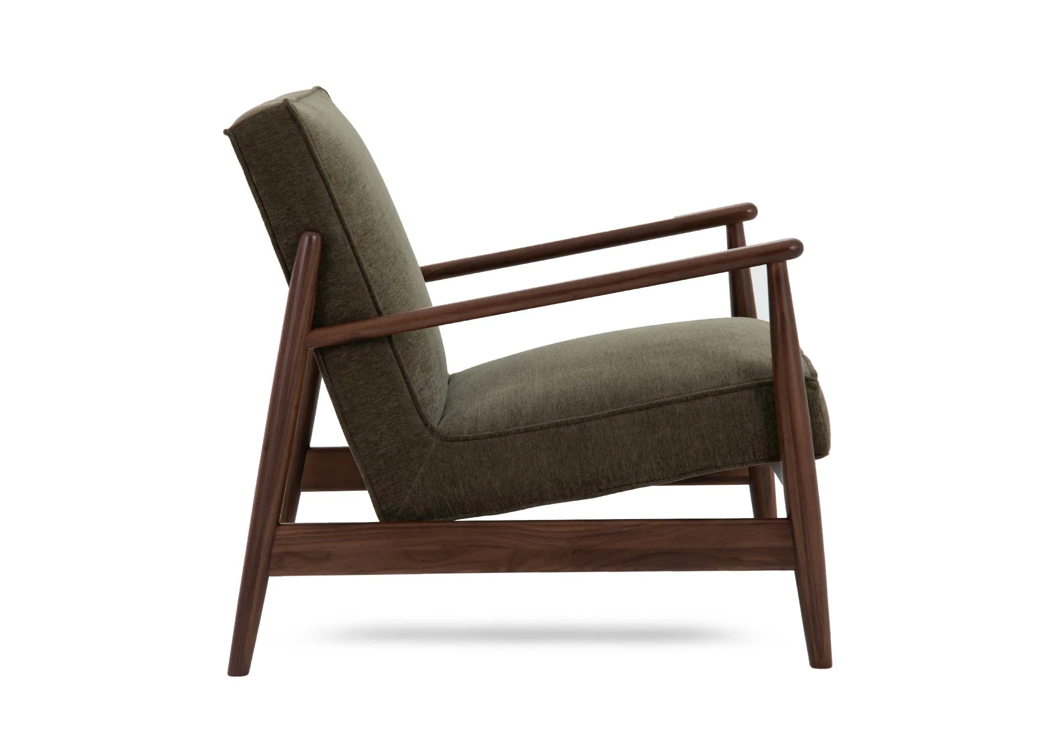 A green fabric lounge chair from EZ Livings Jordan range. Side view of low and leaining seat.