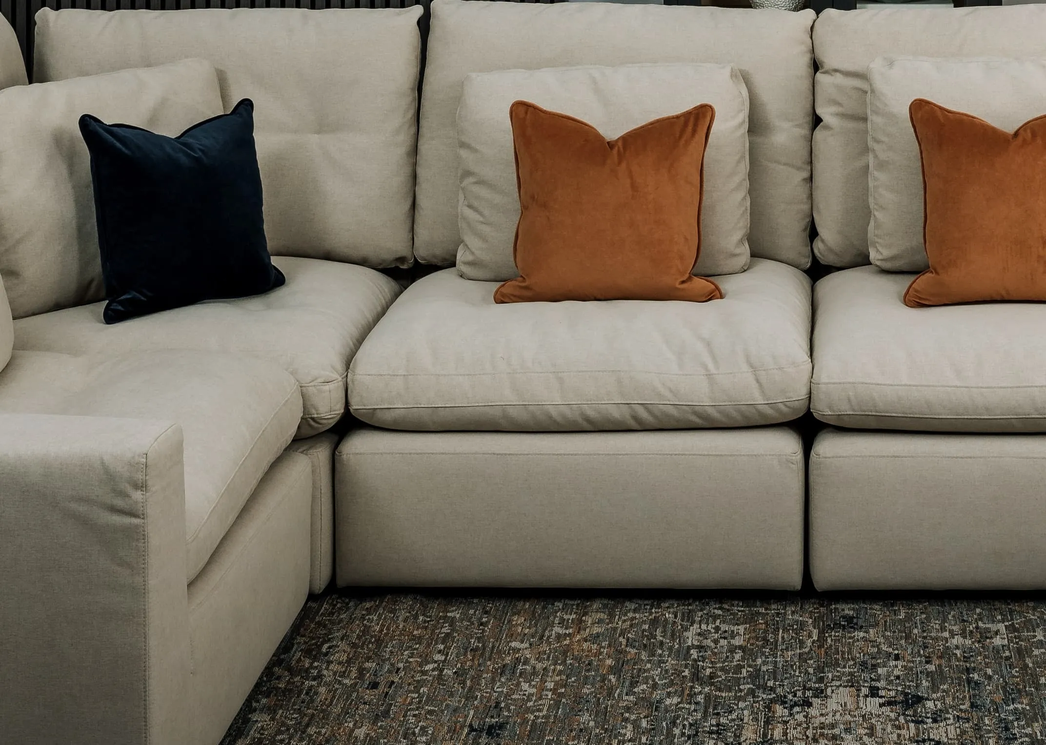A lifestyle image of the Cozy armless unit inserted into the Cozy medium corner sofa to make a large sofa.