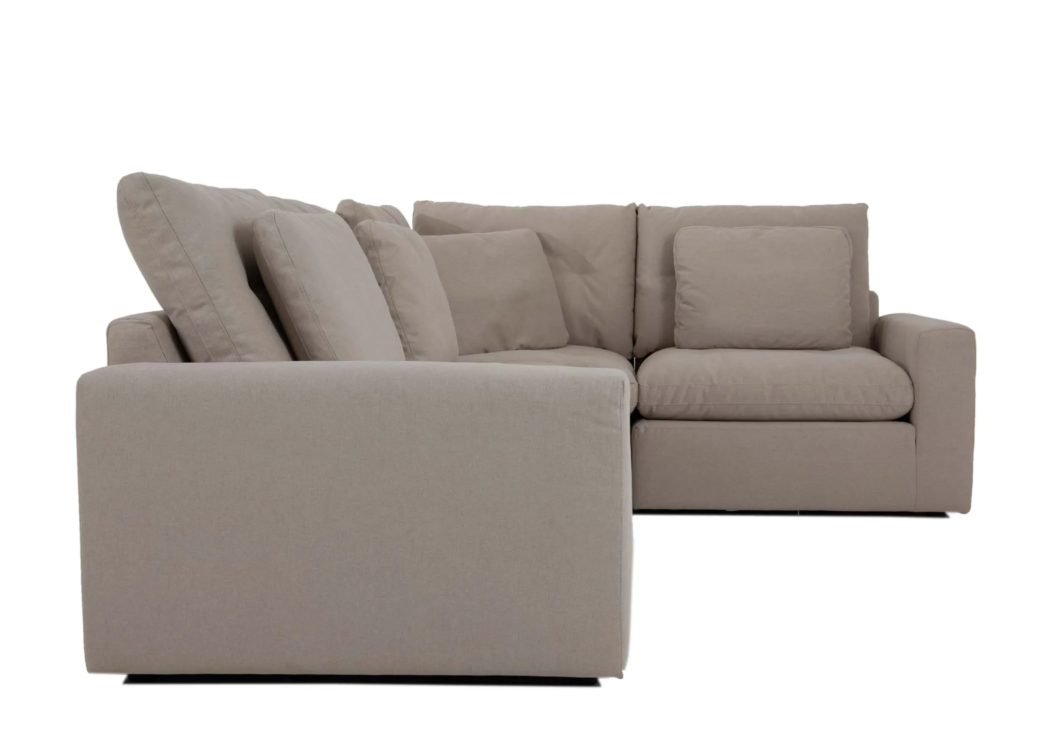 A medium light grey corner sofa from EZ Livings Cozy range. Side view of large arms show deep seats.