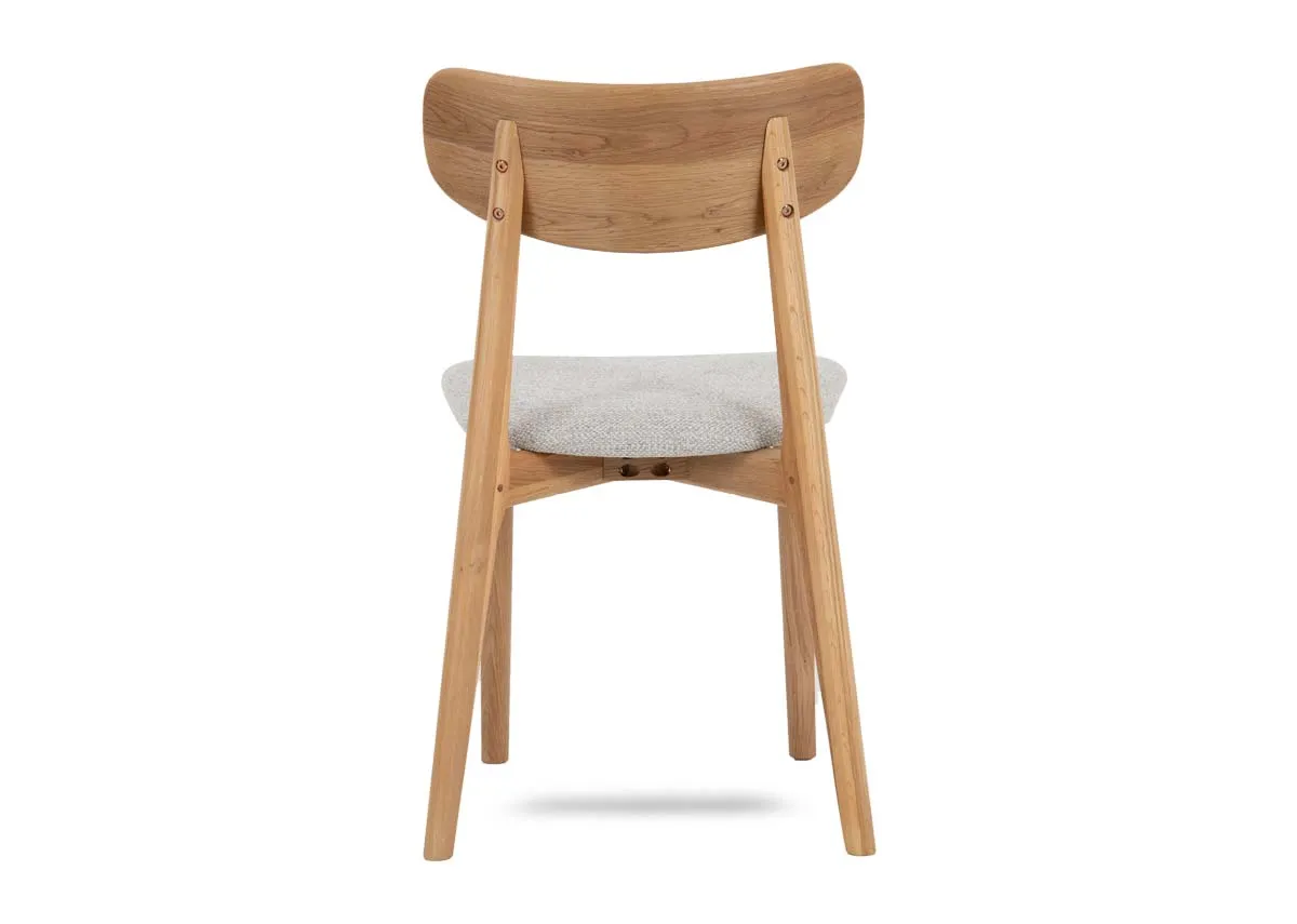 An oak dining chair with cream fabric seat from EZ Livings Bari range. Back view of oak frame