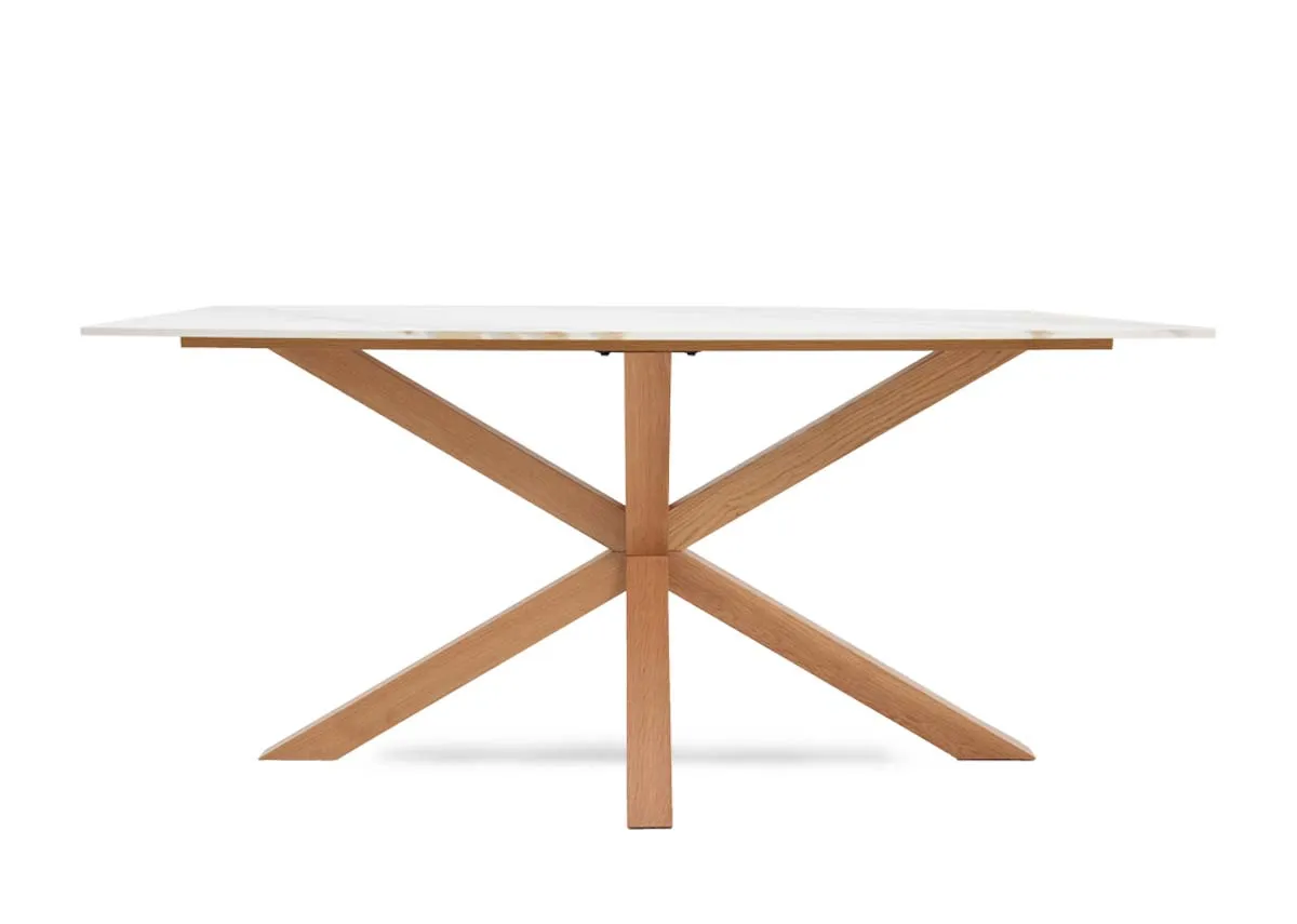 A rectangular melamine top dining tabel with oak legs from EZ Livings Ravello range.Closeup of the white marble look top