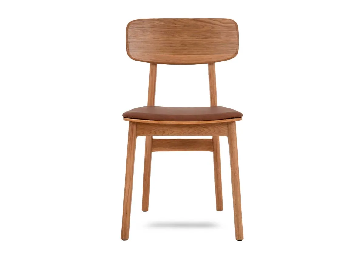 An oak framed dining chair with tan pu seat from EZ Livings Ravello range. Front view of arched seat back.