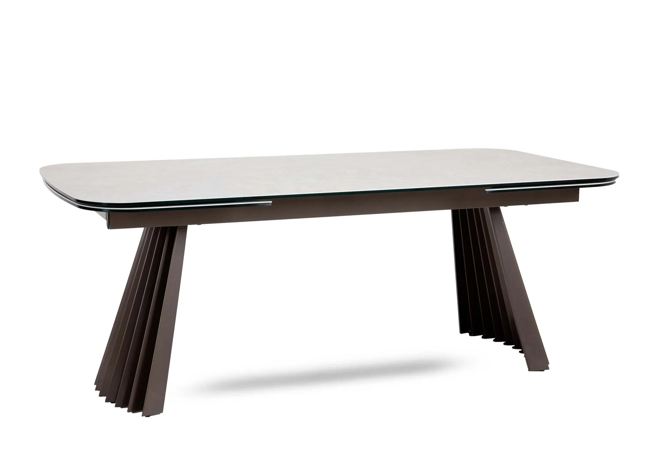 A light grey ceramic dining table with brown pleated metal legs from EZ Livings Fulton range. Angled view of fanned legs either side.