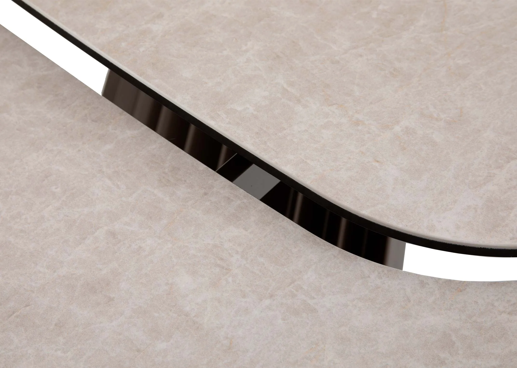 A light grey ceramic dining table with brown pleated metal legs from EZ Livings Fulton range. Closeup of extendable leaves on either side.