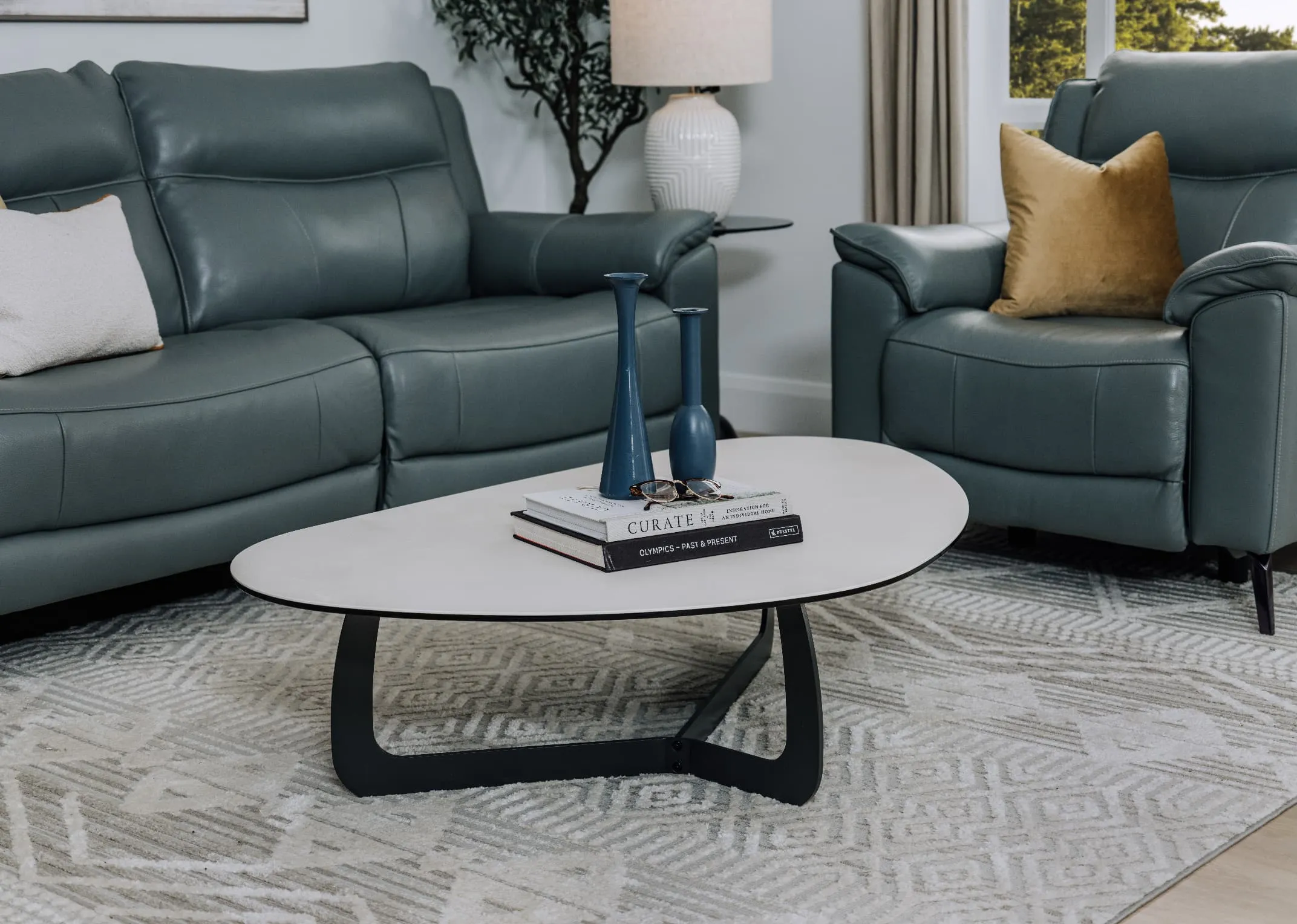 A lifestyle image of the Verona leather sofa range with Sheraton table and blue candle holders.
