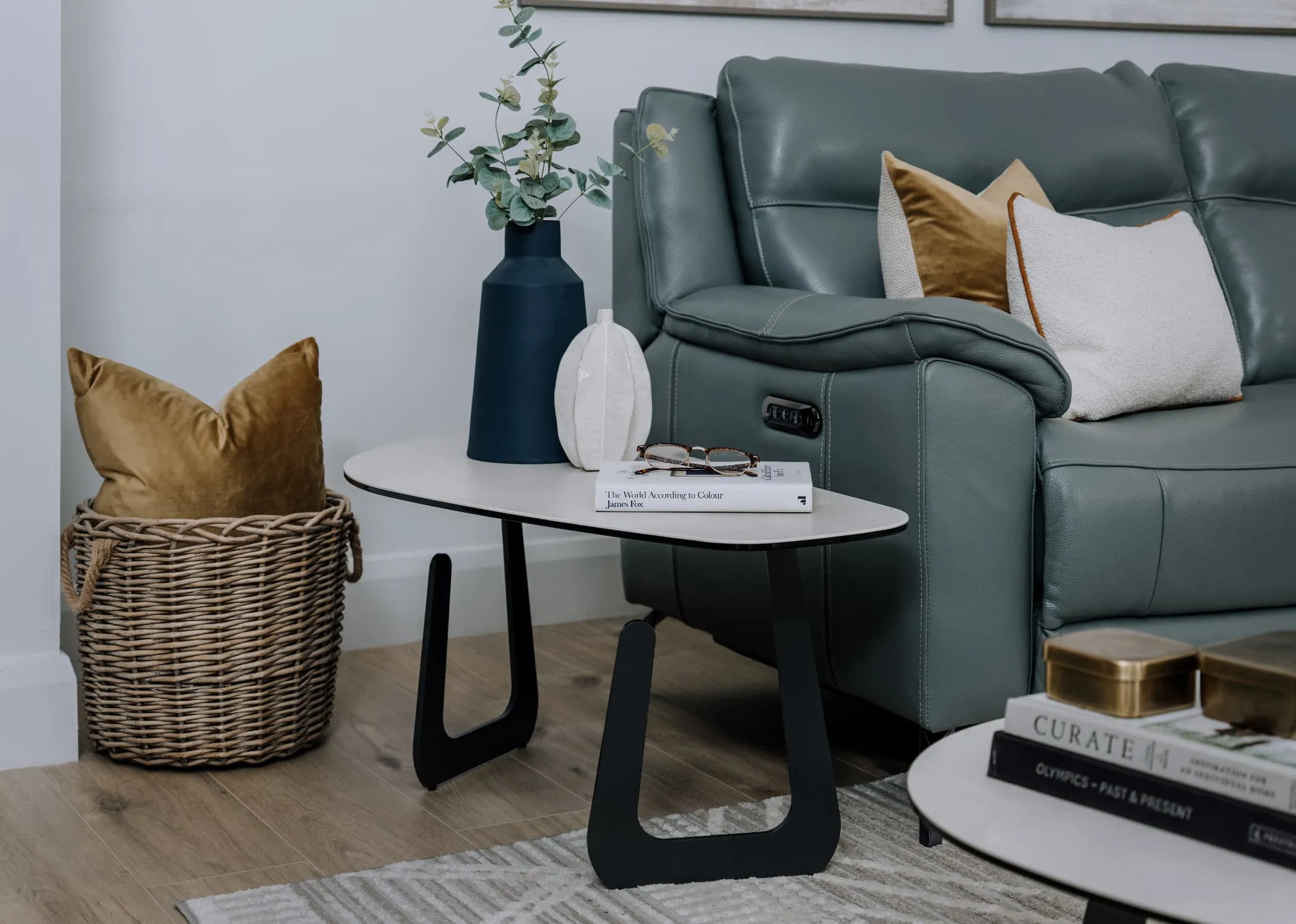 An off white oblong shaped coffee table with black legs from EZ Livings Sheraton range. 