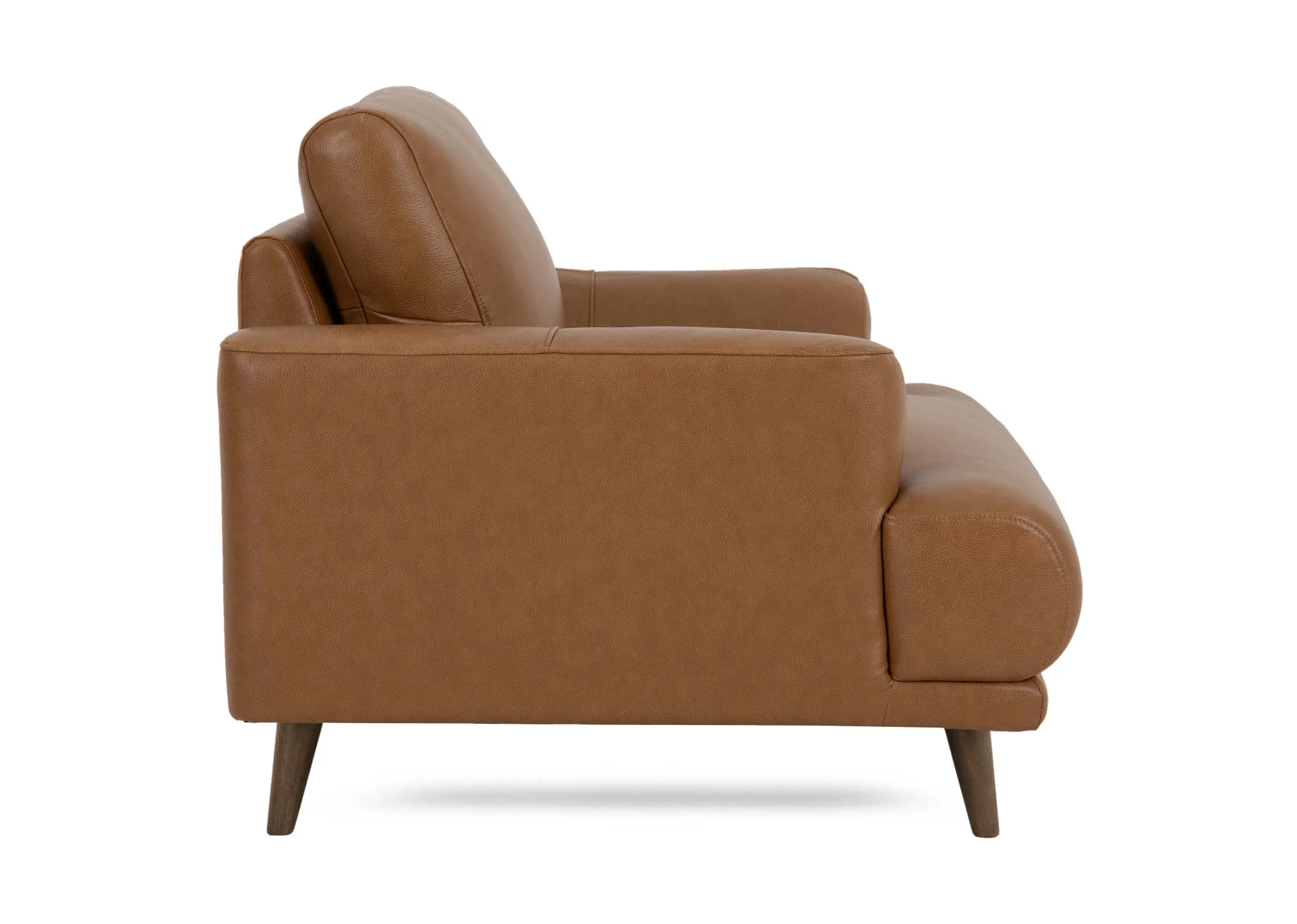 A tan brown leather armchair from EZ Livings Legend range. Side view of long wide arms.