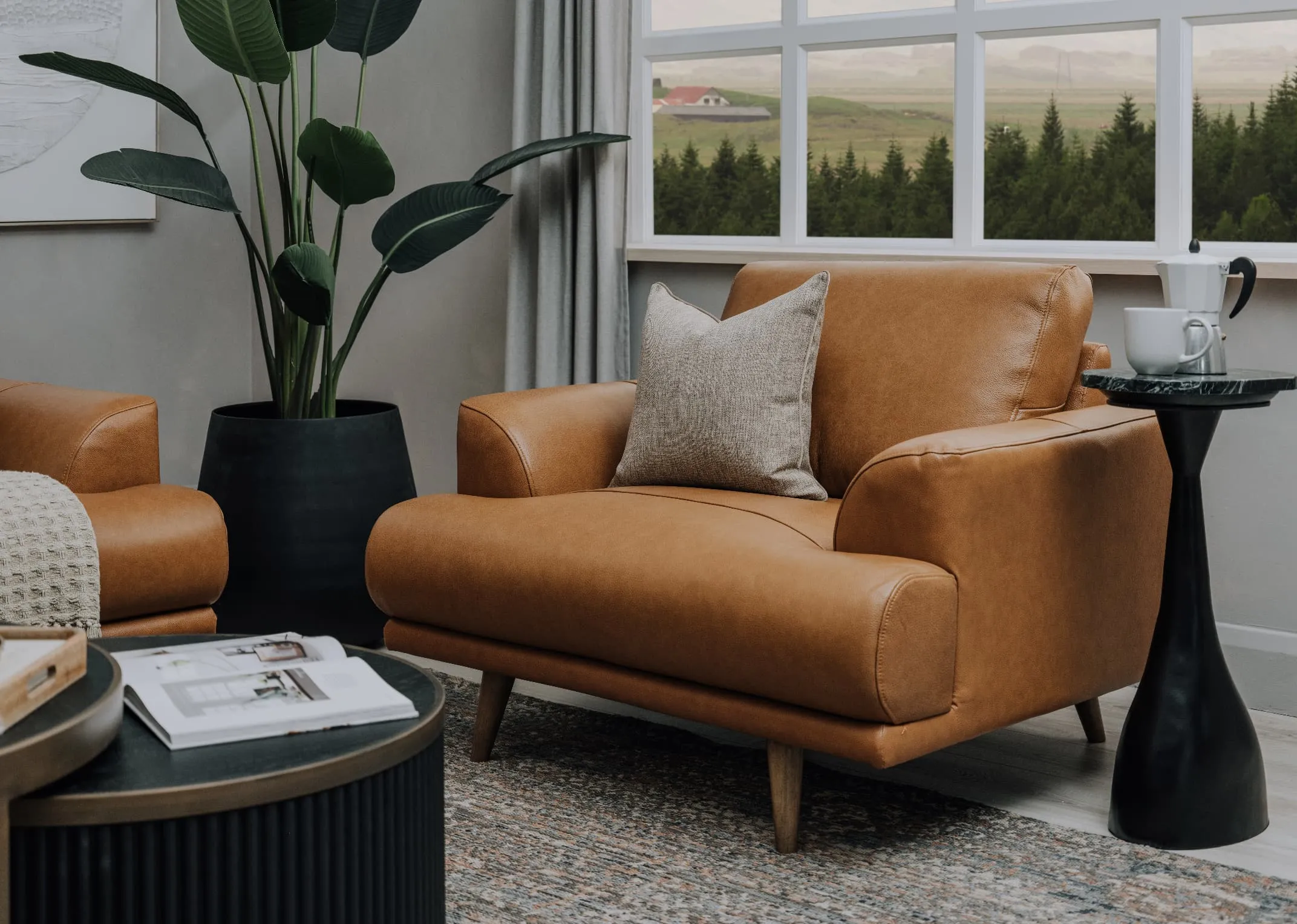 A lifestyle image of the Legend Brown armchair with maxima rug.