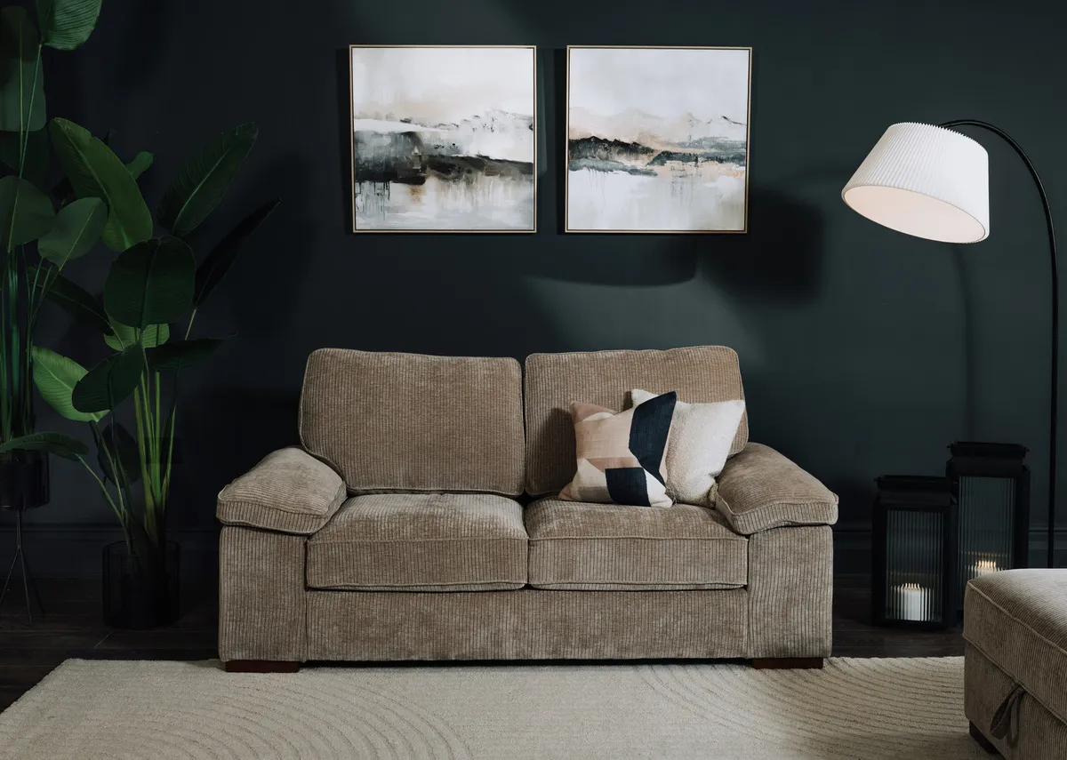A lifestyle image of the Westport 2 seater with Misty canvas pictures and Arc lamp.