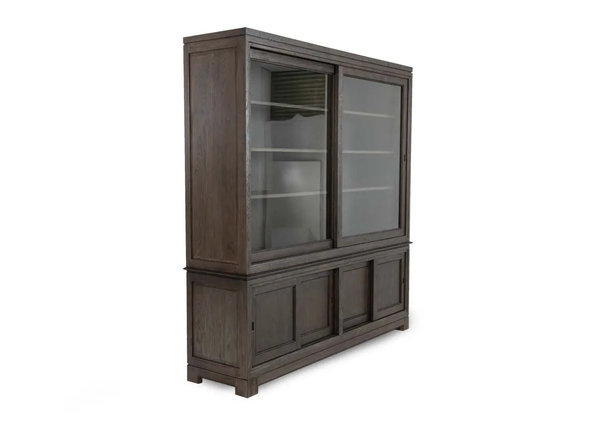 A 4 door display brown wood cabinet from EZ Livings Belleek range. Angled view of 2 large glass doors.