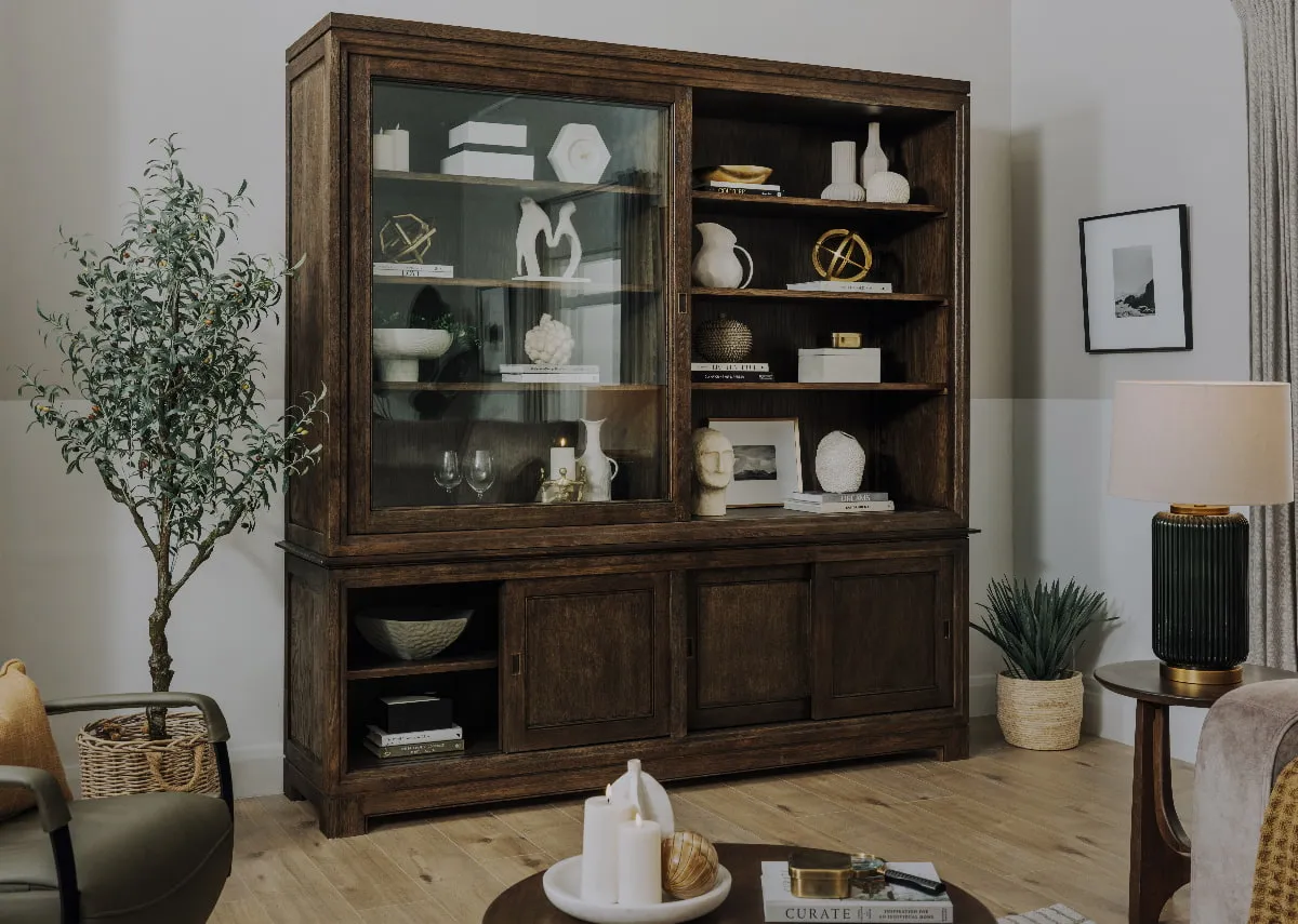 A lifebstyle image of the Belleek cabinet with one glass and one wood door slid across.
