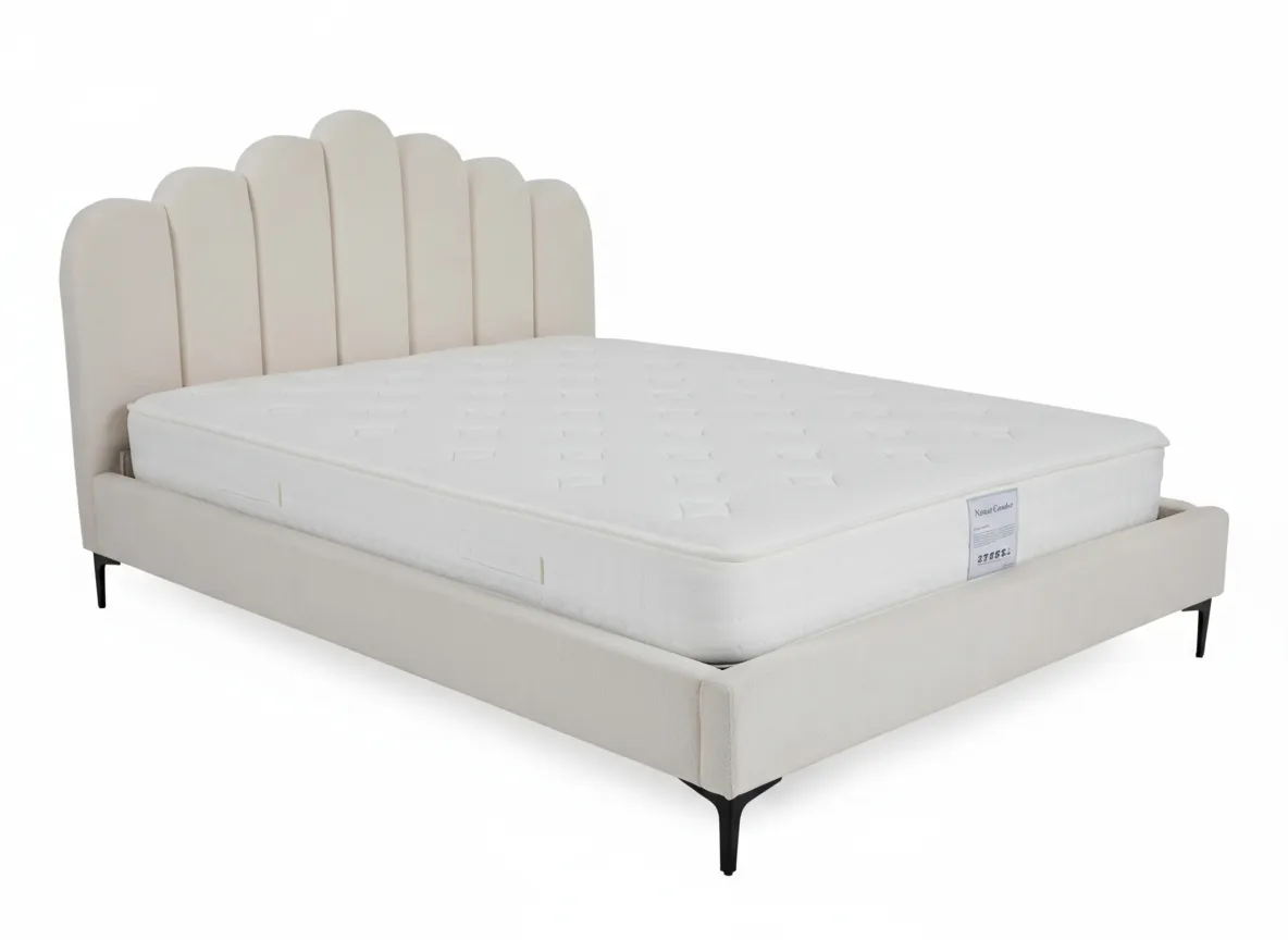A cream velvet bedframe with scallop headboard from EZ Living Furnitures Faye range. Angled view of the bed with mattress not included.