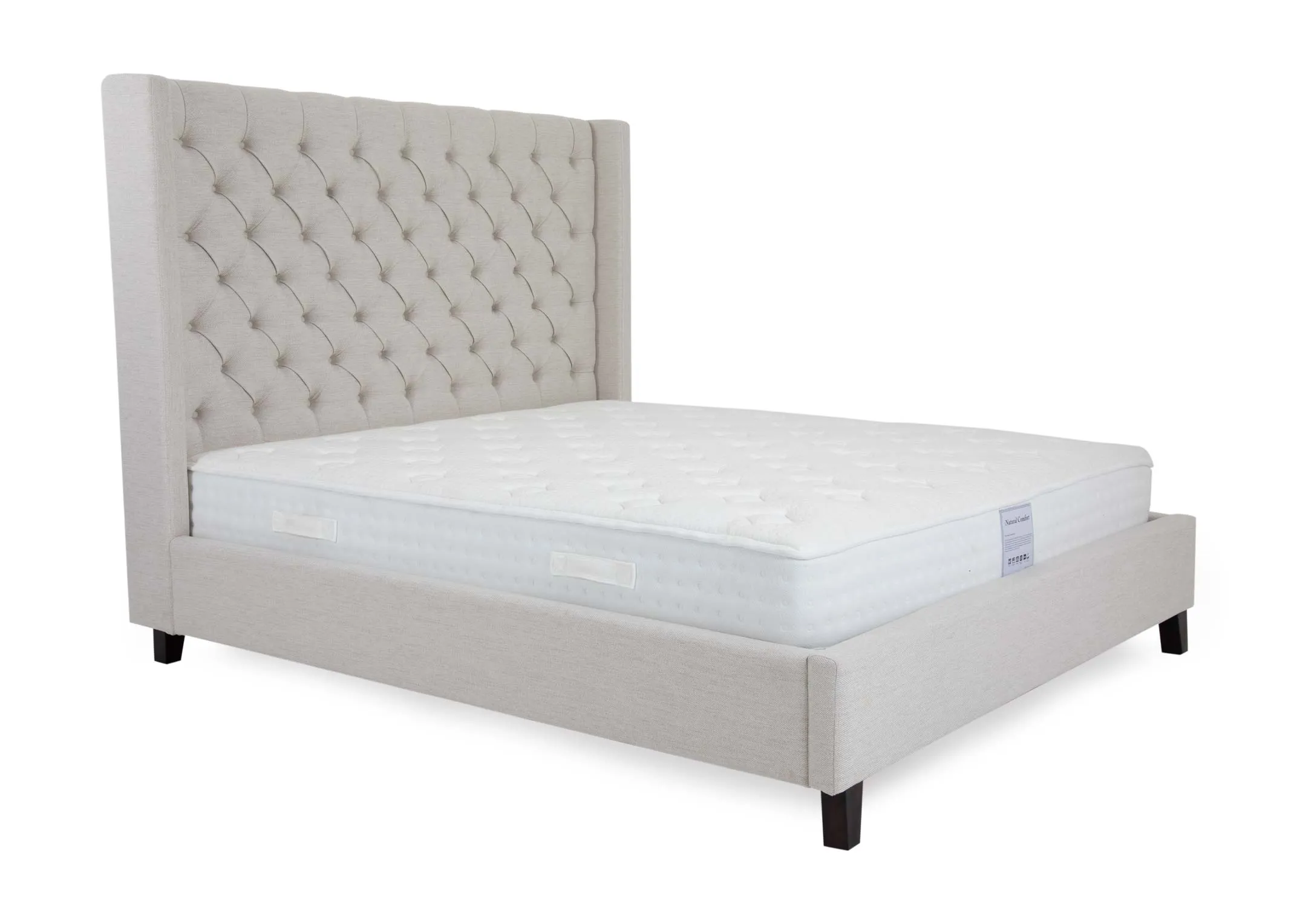 A cream fabric bedframe with high tufted headboard from EZ Livings Enhance range. Angled view of bed with mattress not included.