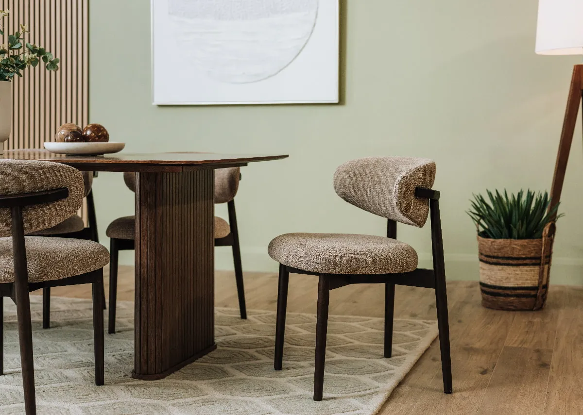 A lifestyle image of the Hazel dining chair with the Nola smoked oak dining table.