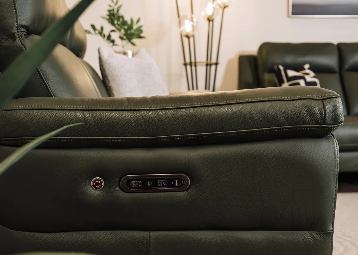 A lifestyle image of the Elliot power reclining sofas remote control and usb charging port.