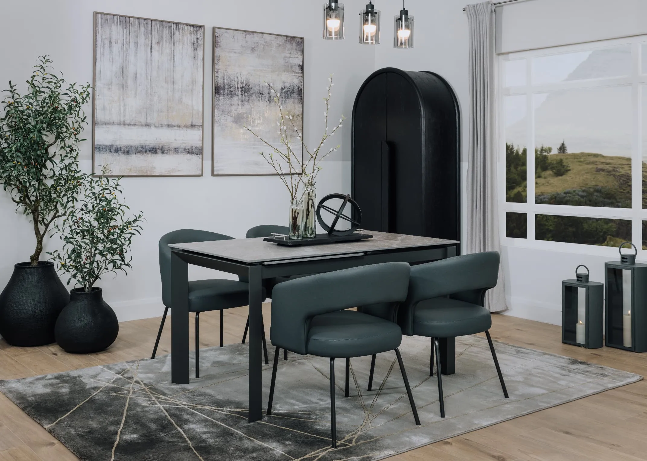 A lifetsyle image of the Samara grey table wih avery rug and Matteo chairs.