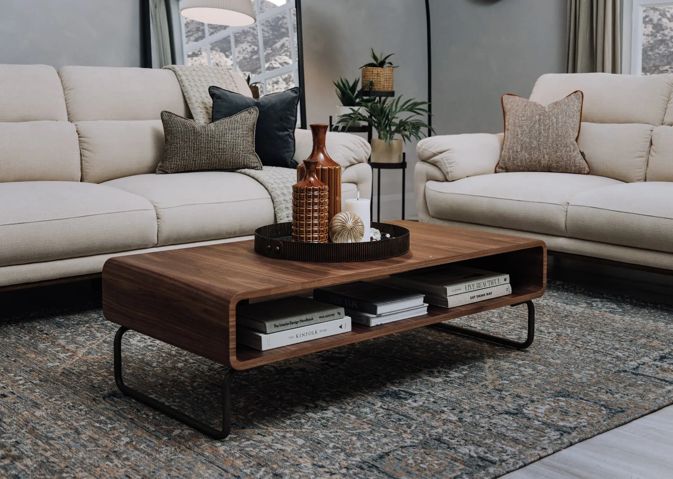 A lifestyle image of the Pippa sofas and Uptown coffee table with tray and vases.