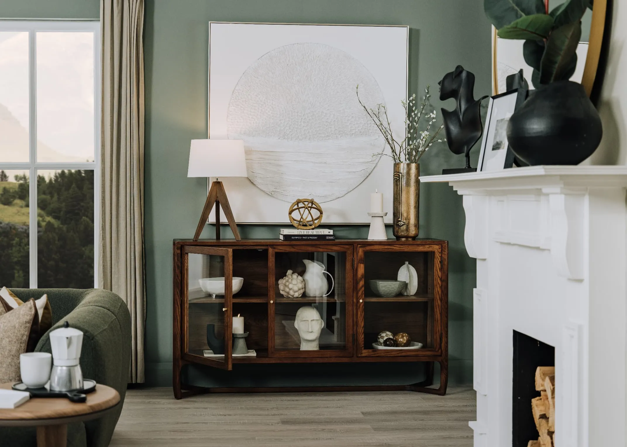 A lifetsyle image of the Cameo sideboard filled with a selection of ornaments and candle holders with Tripod table lamp with Pathways picture.