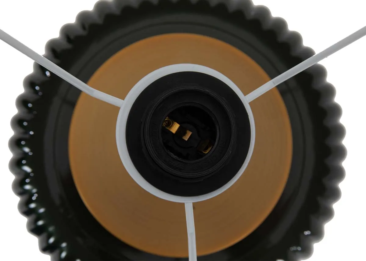 A ribbed gloss black table lamp with large white shade from EZ Livings Vail range. Closeup of brass fittings and