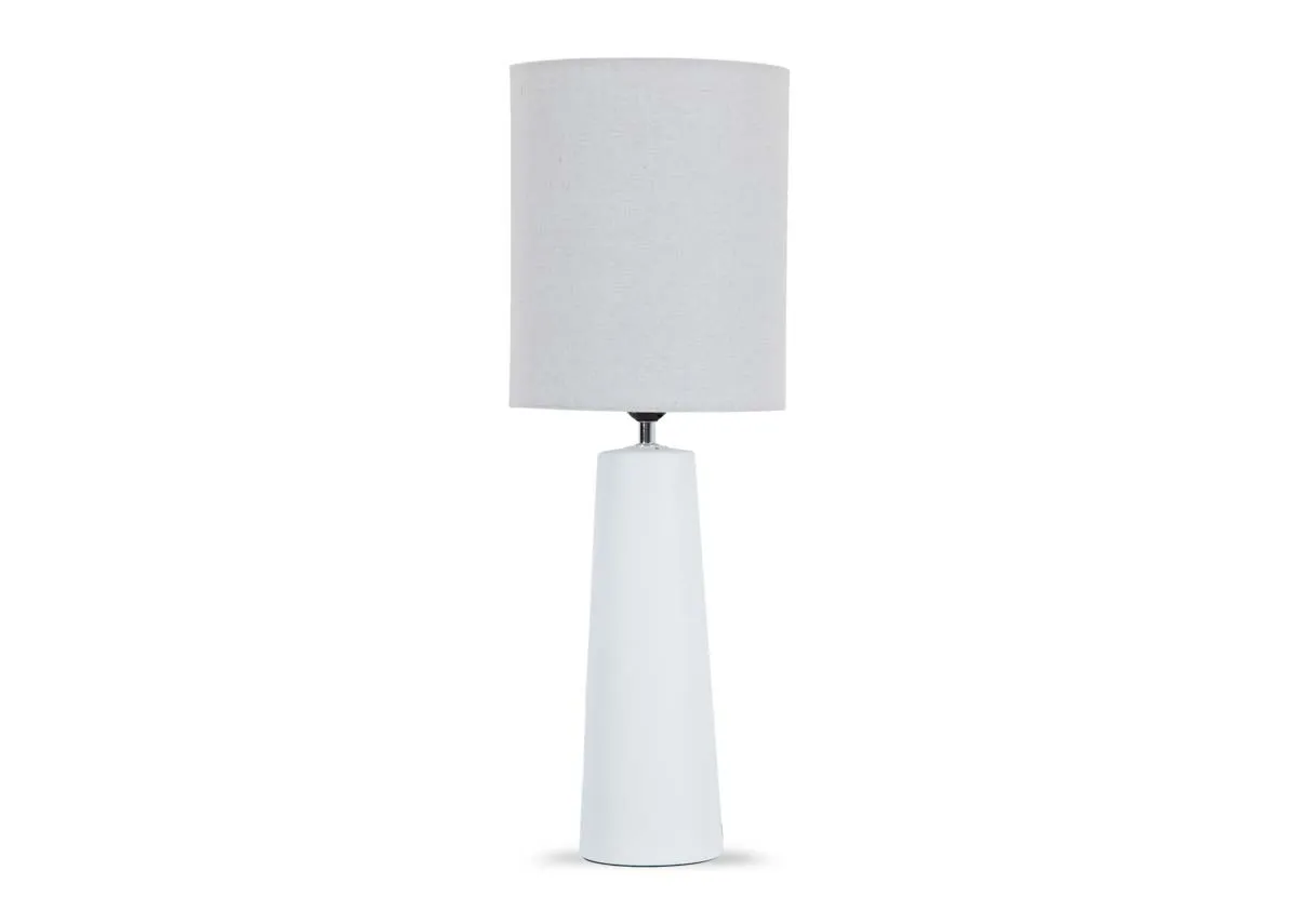 A tall white table lamp from EZ Livings Inny range. Front view of long white stem and tall shade.