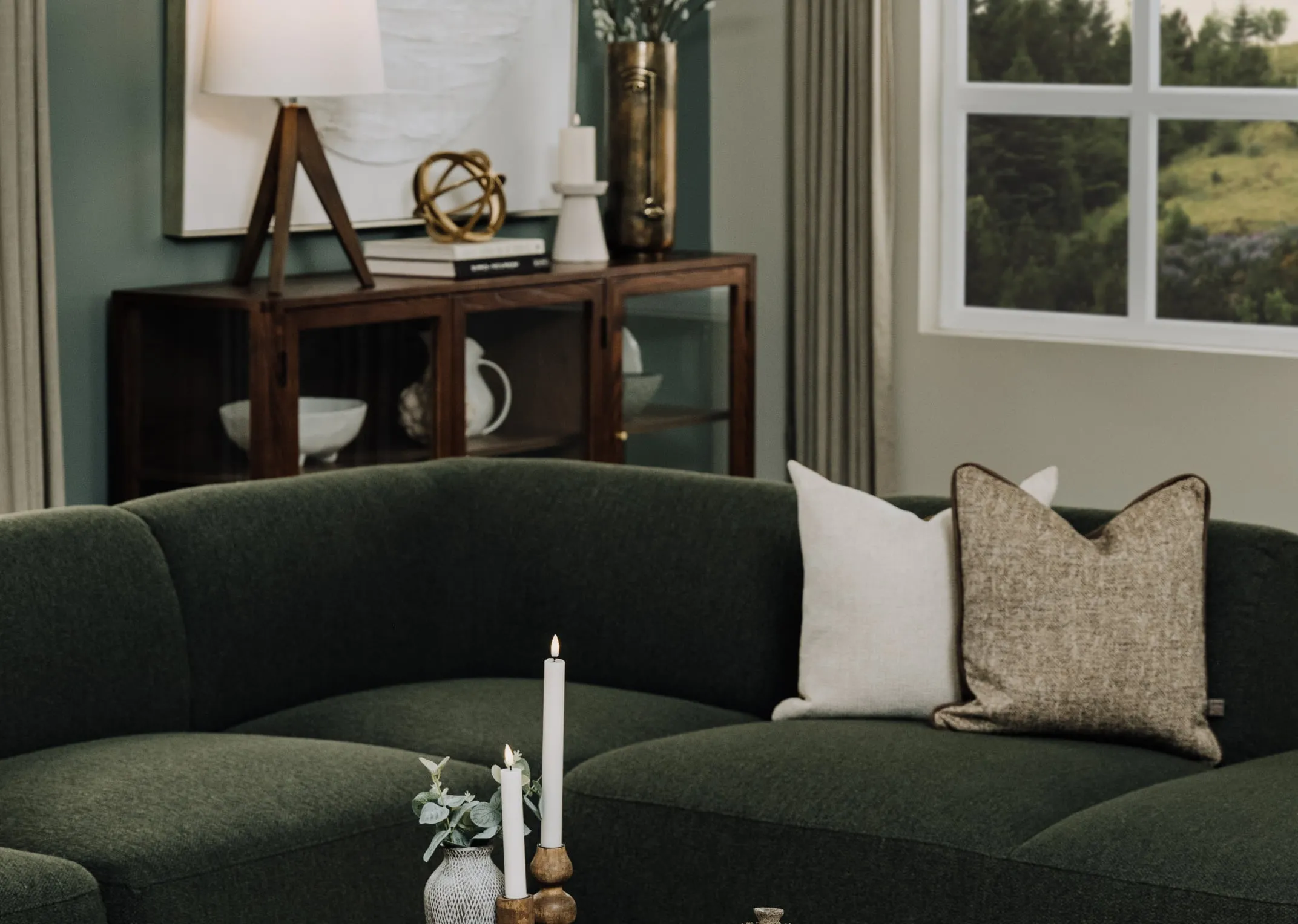 A lifestyle image of the Inishmurray cushion on the Mia green corner sofa with Cameo sideboard.