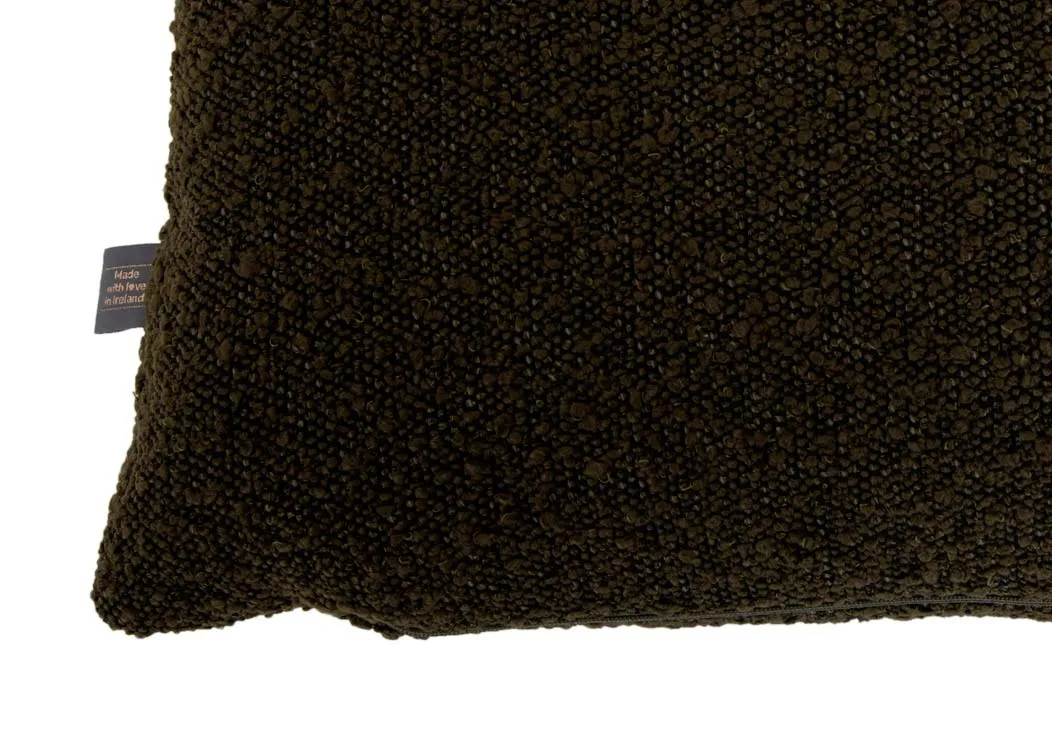 A dark green boucle bolster cushion from EZ Livings Benbulbin range. Closeup of fabric