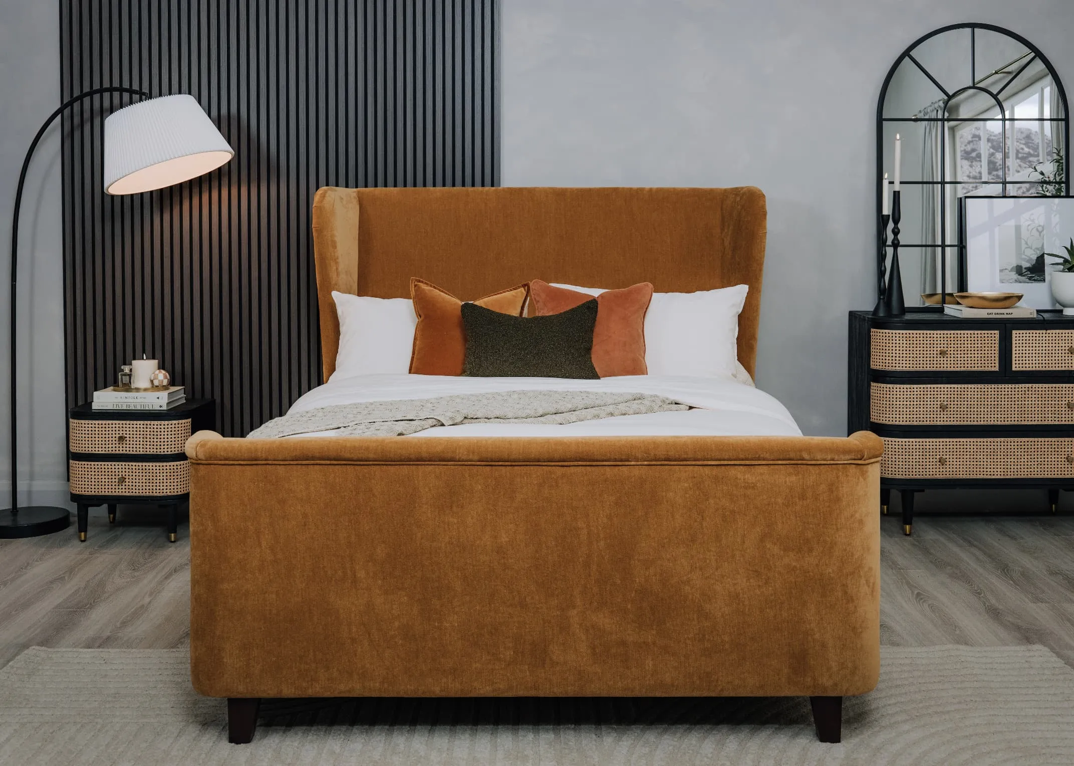 A lifestyle image of the Maison bed with benbulbin cushion and rust velvet cushions