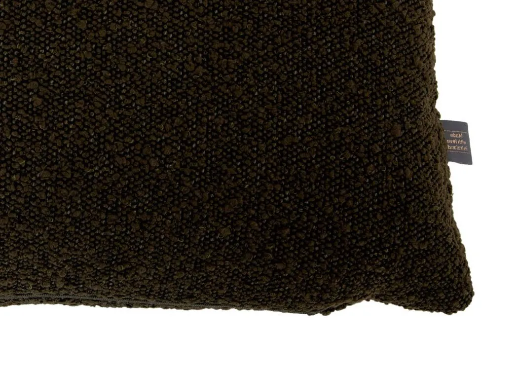 A dark green boucle bolster cushion from EZ Livings Benbulbin range. Closeup of boucle texture