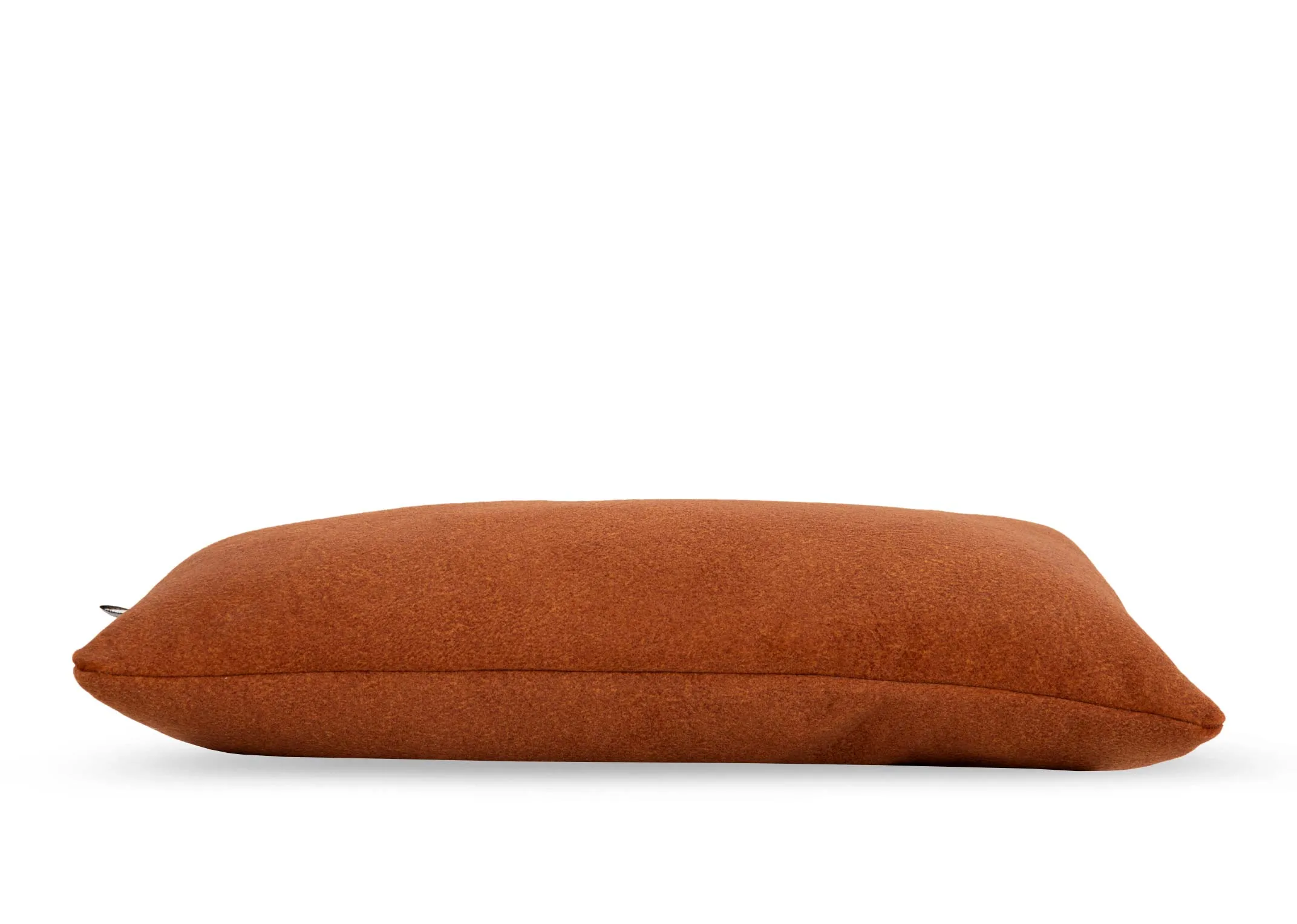 An orange fabric bolster cushion from EZ Livings Easkey range. Side view of removable cover