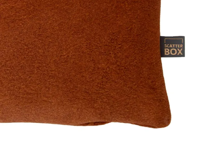 An orange fabric bolster cushion from EZ Livings Easkey range. Closeup of luxury fabric