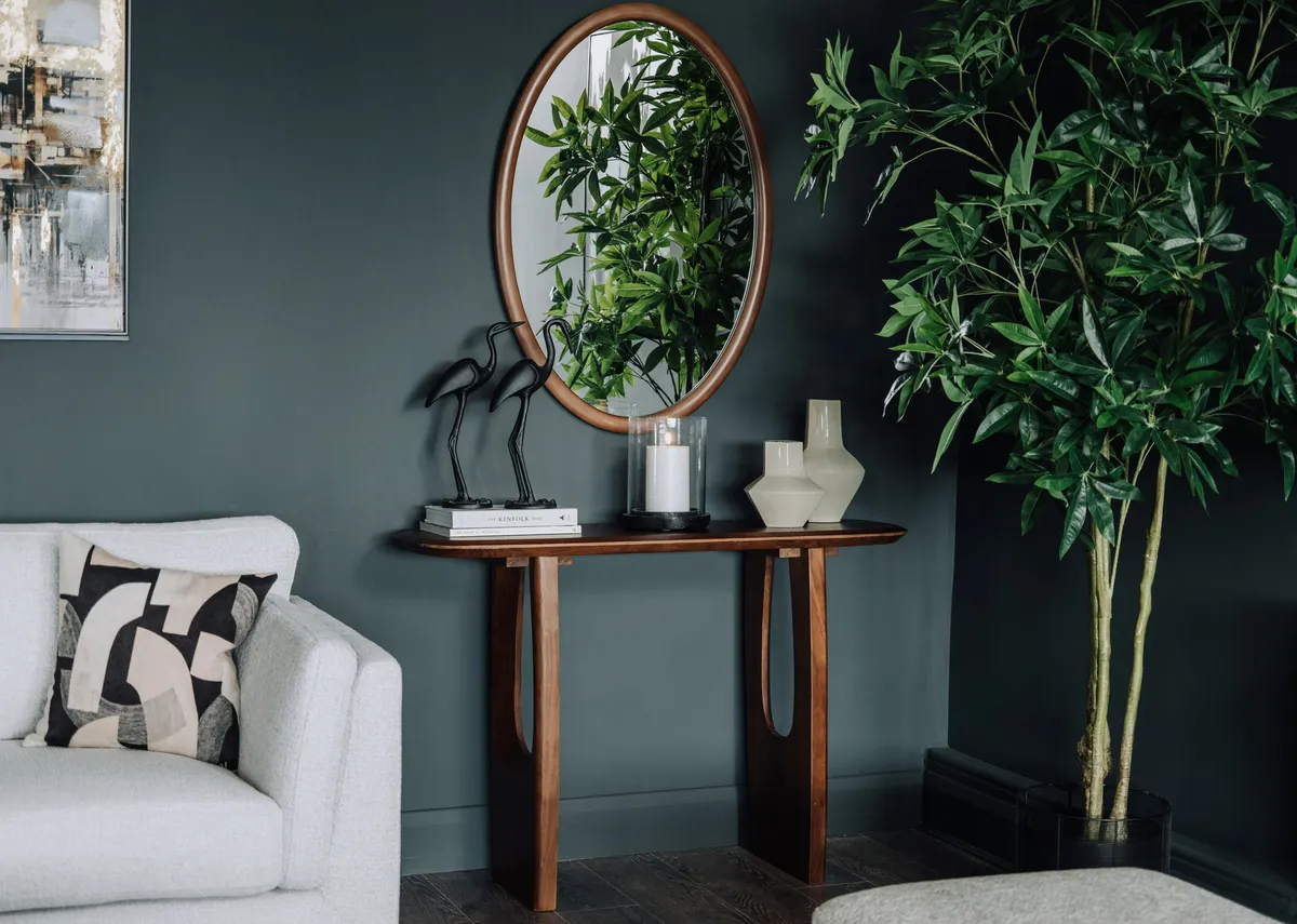 A lifestyle image of the Vita Mirror with the Jet console table in brown.
