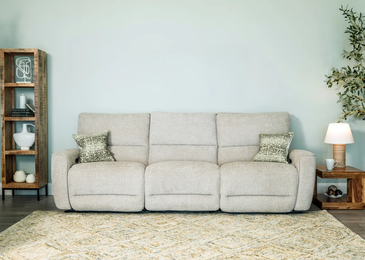 A lifestyle image of the Ashbrook sofa with green cushions and Avoca bookcases.