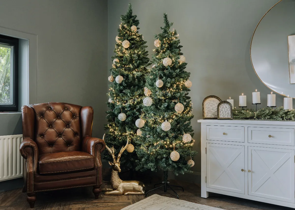 A lifestyle image of the Noble Trees with Adare armchair and large reindeer figurine.