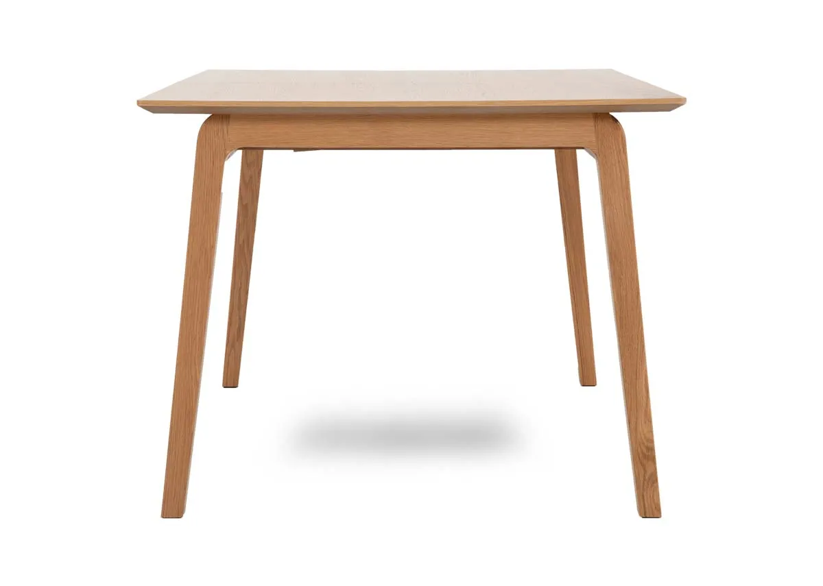 A natural oak dining table from EZ Livings Bari range. Side view
