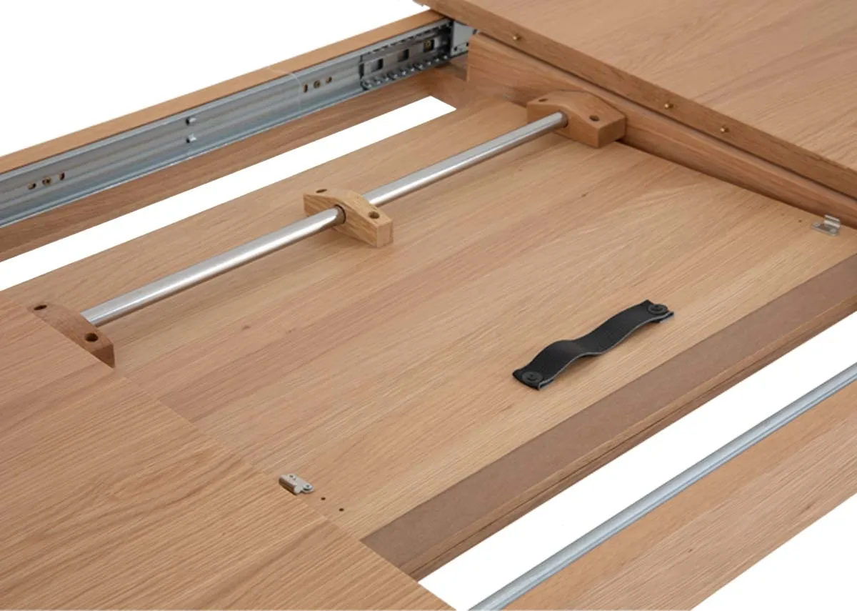 A natural oak dining table from EZ Livings Bari range. Closeup of extension leaf below table