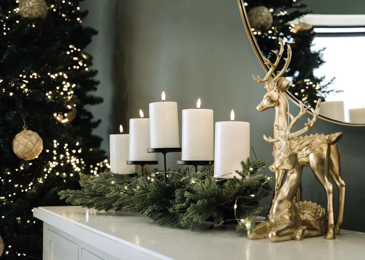 A lifestyle image of the Pine Needle Candle Holder with Standing & lying reindeer oranments.