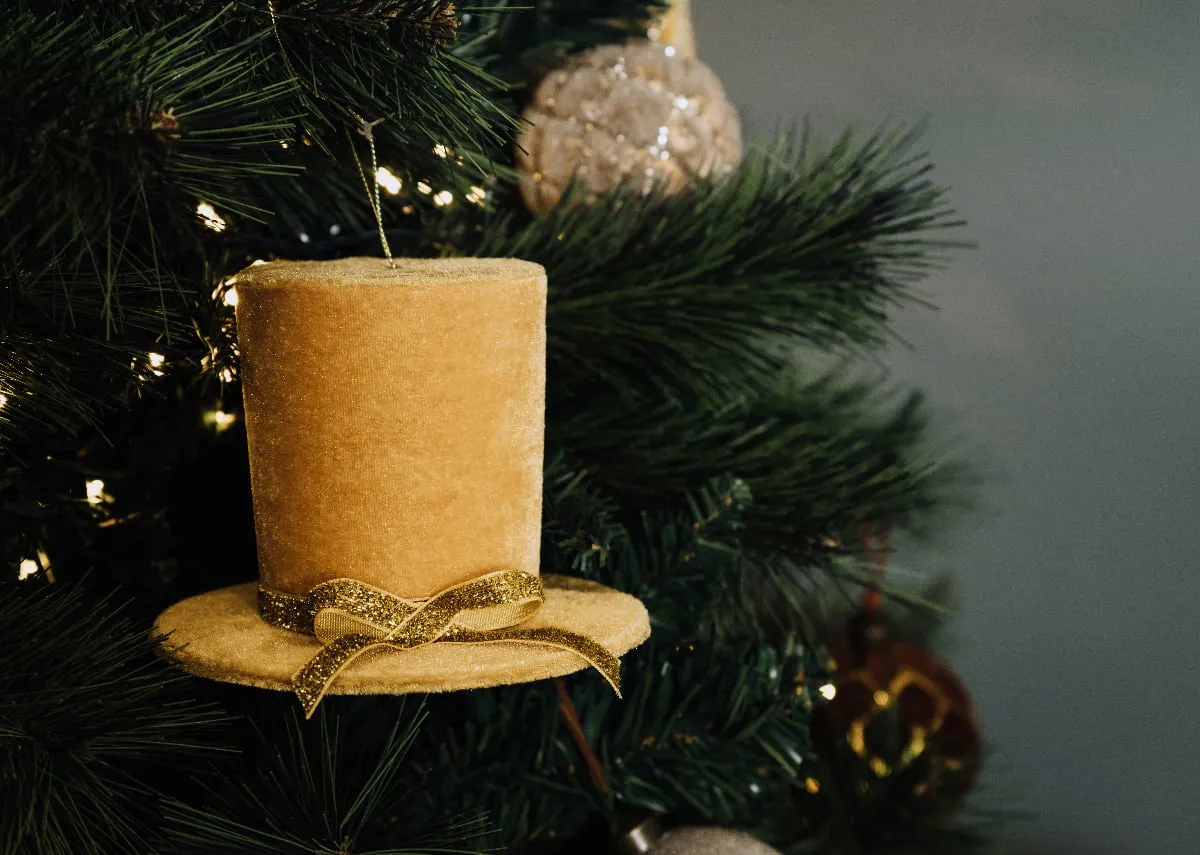 A lifestyle image of the Gold Top Hat Bauble on the Rockefeller tree.