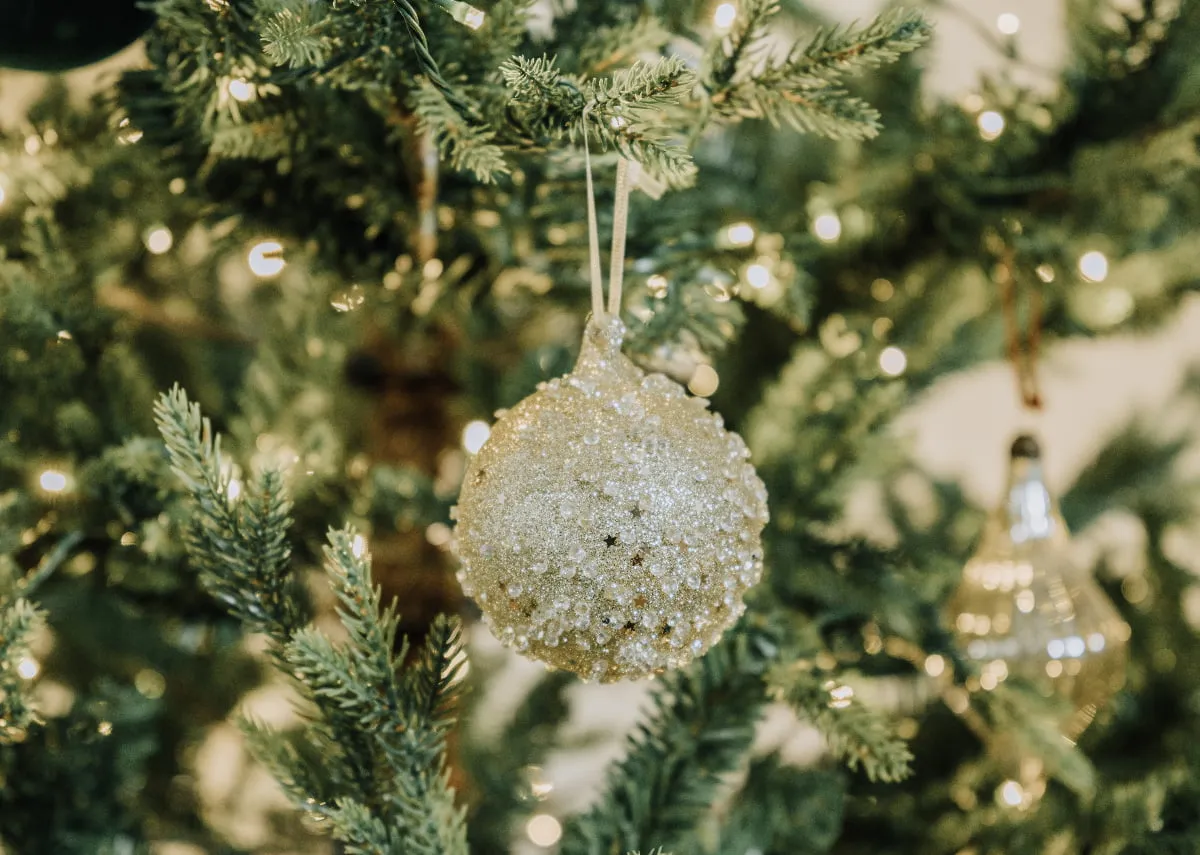A lifetsyle image of the O christmas tree bauble on the Douglas tree.