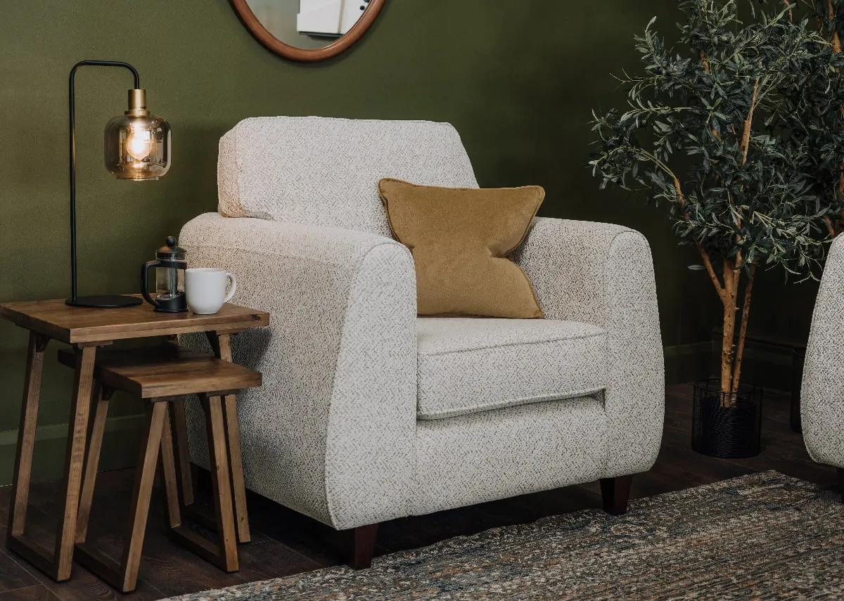 A Waterville armchair with a nest of 2 ladder tables